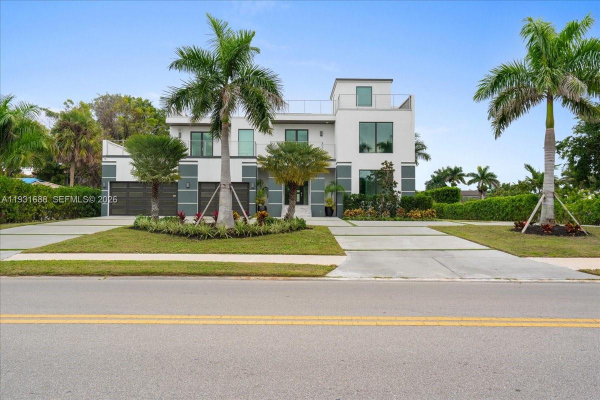 Located across from the water, enjoy waterfront views from entertainers deck! Built in 2023, this exceptional 4-bedroom, 6-bath residence offers the rare opportunity to own a nearly new luxury home in one of Naples’ most sought-after locations—without the premium pricing of waterfront properties. Home features 4 bedrooms and 6 bathrooms with thoughtfully designed living and entertaining spaces throughout. Features include two laundry rooms, a 3-car air-conditioned garage, second-floor wet bar, and multiple indoor-outdoor living areas. The chef’s kitchen is equipped with top-tier appliances, custom cabinetry, and generous workspace, opening seamlessly to the main living areas with soaring ceilings and refined finishes. A private elevator services all levels, including a fully built-out rooftop retreat featuring an outdoor summer kitchen, cabana bath, and water views—ideal for elevated entertaining. Outdoor amenities include a resort-style pool and spa, covered entertaining areas, and lush landscaping. Built with concrete block construction, impact-resistant windows and doors, and premium materials throughout. Ideally located minutes from the Gulf beaches, Venetian Village, and Fifth Avenue South, this move-in-ready home offers luxury living in one of Naples’ most sought-after neighborhood.  With new construction comes peace of mind: modern systems, current building standards, and no renovation delays.