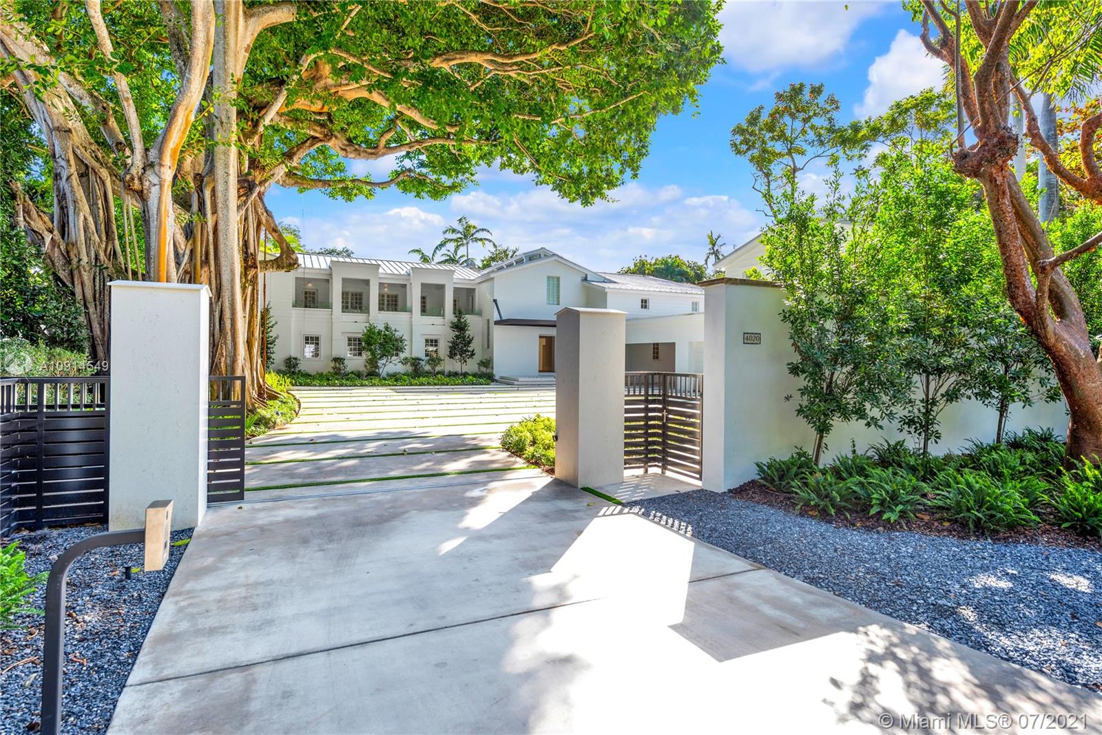 The perfect pairing of the Hamptons and Coconut Grove! Refreshed to absolute perfection and enveloped by a lush, 36,652 SF lot, this Grand residence with guest house evokes contemporary elegance. Located on one of the most prestigious streets in the Grove, this 8 bedroom, 9/1 bathroom masterpiece embodies timeless elegance with modern luxuries.  With interior designs by Jessica Jaegger, the home features 35' ceilings in the main living room, a Gourmet kitchen, Oak Wood floors and marble bathrooms. Detached guest house, elevator, 3 car garage, service quarters with sitting area, Creston System and full house generator complete this one of a kind residence. An absolute must see.