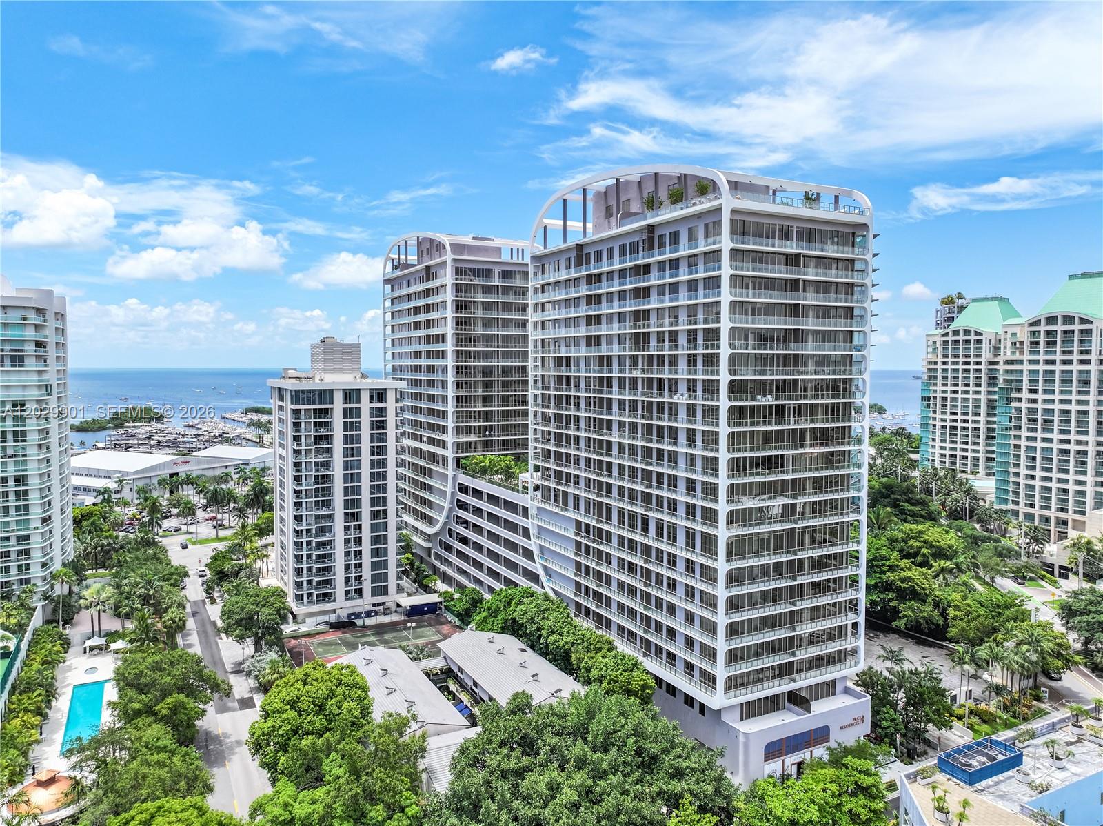 Experience the signature lifestyle of Mr. C Residences Coconut Grove in this corner residence with water views of Dinner Key and Biscayne Bay. Floor-to-ceiling glass and a wraparound terrace fill the home with natural light and the sense of Coconut Grove. Per the developer 1,430 total s.f. Residents enjoy an exceptional collection of amenities, including a rooftop pool with panoramic views, a resort-style pool with cabanas, state-of-the-art fitness and wellness facilities, concierge services, and 24-hour valet and doorman. Ideally located close to Coconut Grove's acclaimed restaurants, boutiques, marinas, parks, and waterfront attractions. Includes two valet parking spaces and the impeccable service and lifestyle for which Mr. C is renowned.