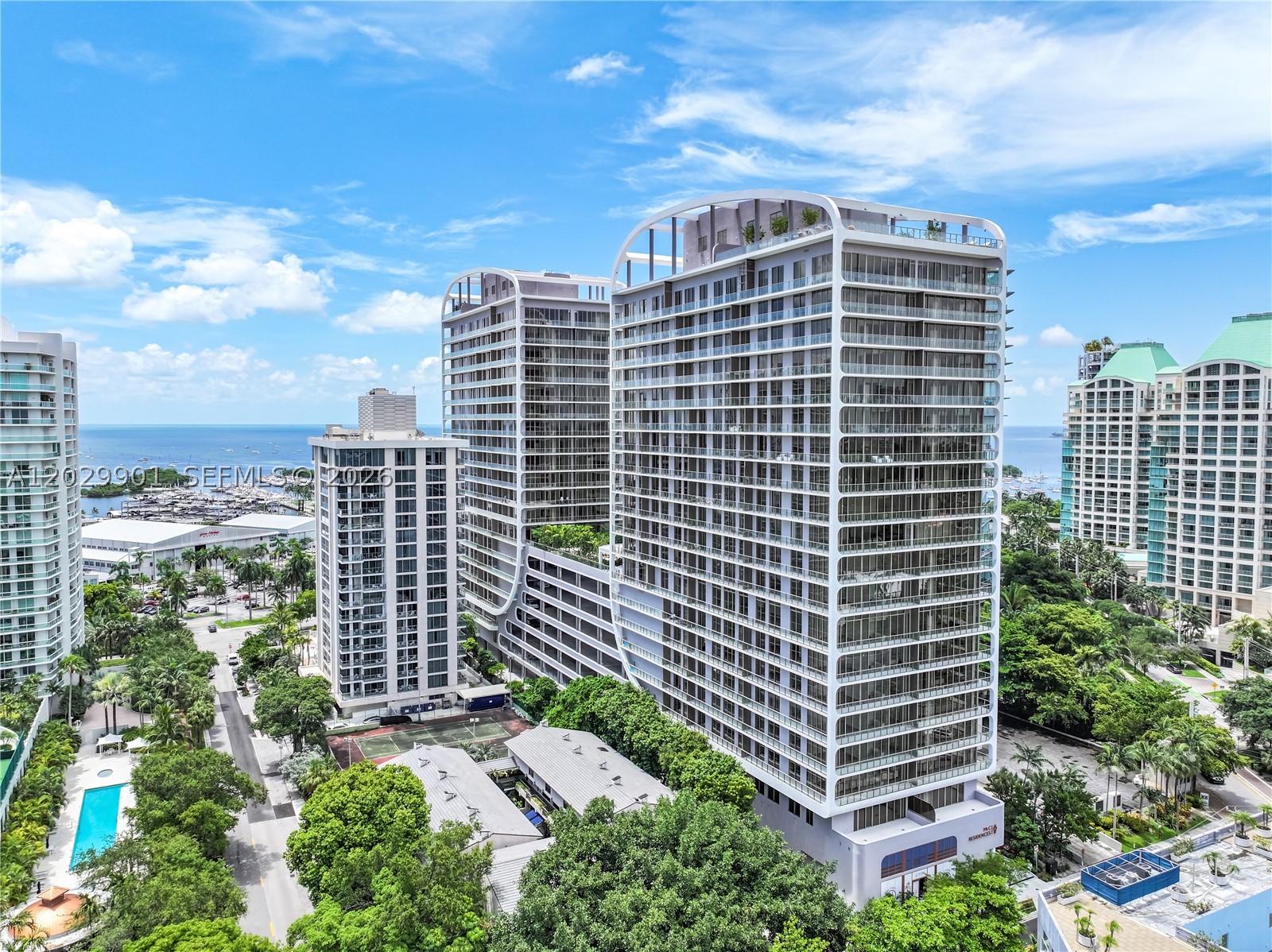 Experience the signature lifestyle of Mr. C Residences Coconut Grove in this corner residence with water views of Dinner Key and Biscayne Bay. Floor-to-ceiling glass and a wraparound terrace fill the home with natural light and the sense of Coconut Grove. Per the developer 1,430 total s.f. Residents enjoy an exceptional collection of amenities, including a rooftop pool with panoramic views, a resort-style pool with cabanas, state-of-the-art fitness and wellness facilities, concierge services, and 24-hour valet and doorman. Ideally located close to Coconut Grove's acclaimed restaurants, boutiques, marinas, parks, and waterfront attractions. Includes two valet parking spaces and the impeccable service and lifestyle for which Mr. C is renowned.