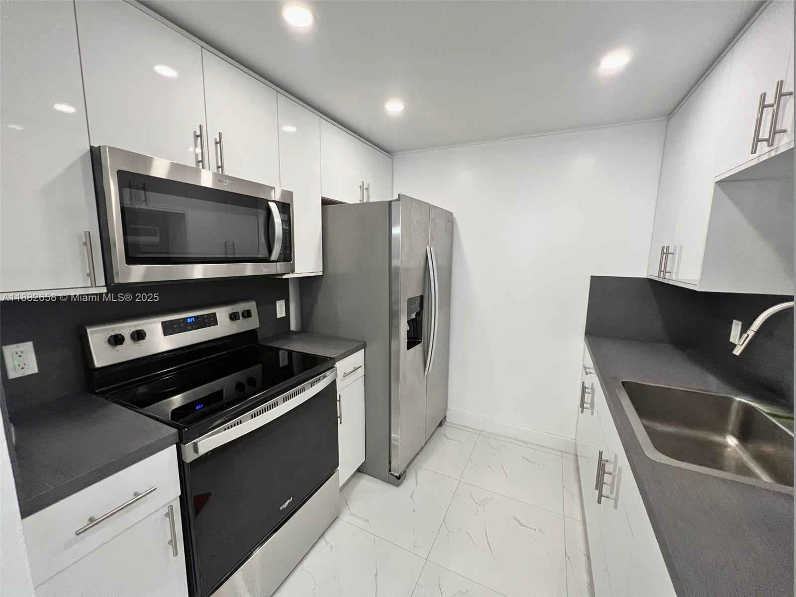 Turnkey investment opportunity in Century Village, Pembroke Pines' premier 55+ gated community. Tenant in place paying $1,650/month through November 2026 — start collecting rent from day one. Beautifully remodeled 1 bed / 1.5 bath featuring waterproof laminate floors, stainless steel appliances, screened covered balcony, and private storage locker included. Resort-style amenities include clubhouse, pools, tennis courts, golf, fitness center, courtesy bus and 24-hour security. 40-year recertification already completed. No rental restrictions. A rare find — don't miss it!