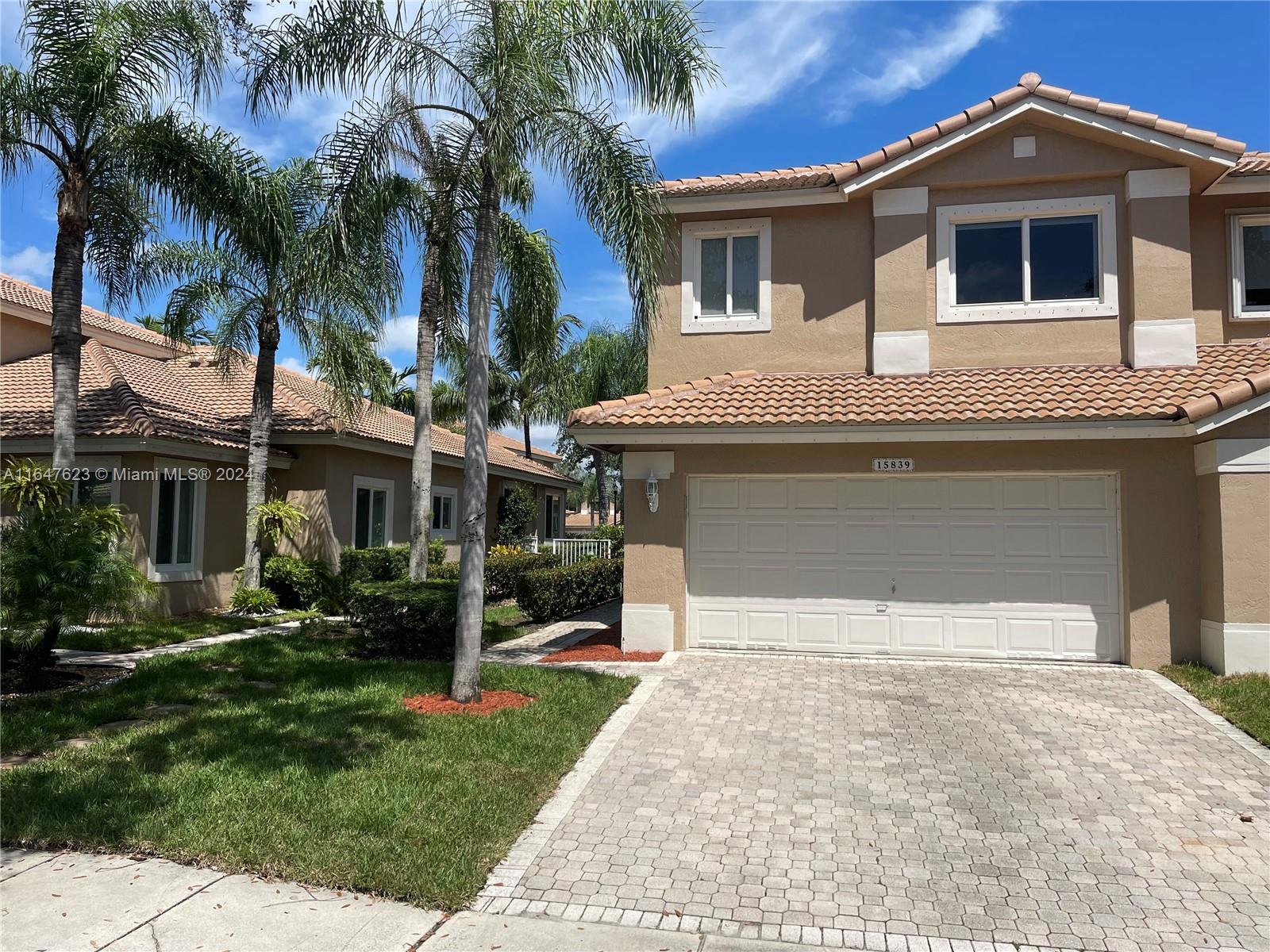 A two-story, 3-bedroom, 2.5-bathroom corner-unit townhouse situated in the desirable Courtyards at Grand Palms Golf & Country Club. This spacious home is filled with natural light and features tall ceilings, wood floors throughout, remodeled bathrooms, and a large two-car garage with an additional paved driveway accommodating two more cars. All bedrooms are located on the second floor. The communal open lawn area behind the property offers extra privacy. Roof replaced 2021 (date of last permit). The community includes a pool within the Courtyards subdivision and is just steps away from the golf course. The HOA covers 24-hour security, exterior painting, landscape and irrigation maintenance. Application fee is $100. Electrical Panel original and model: Square D. HVAC original 12/98.