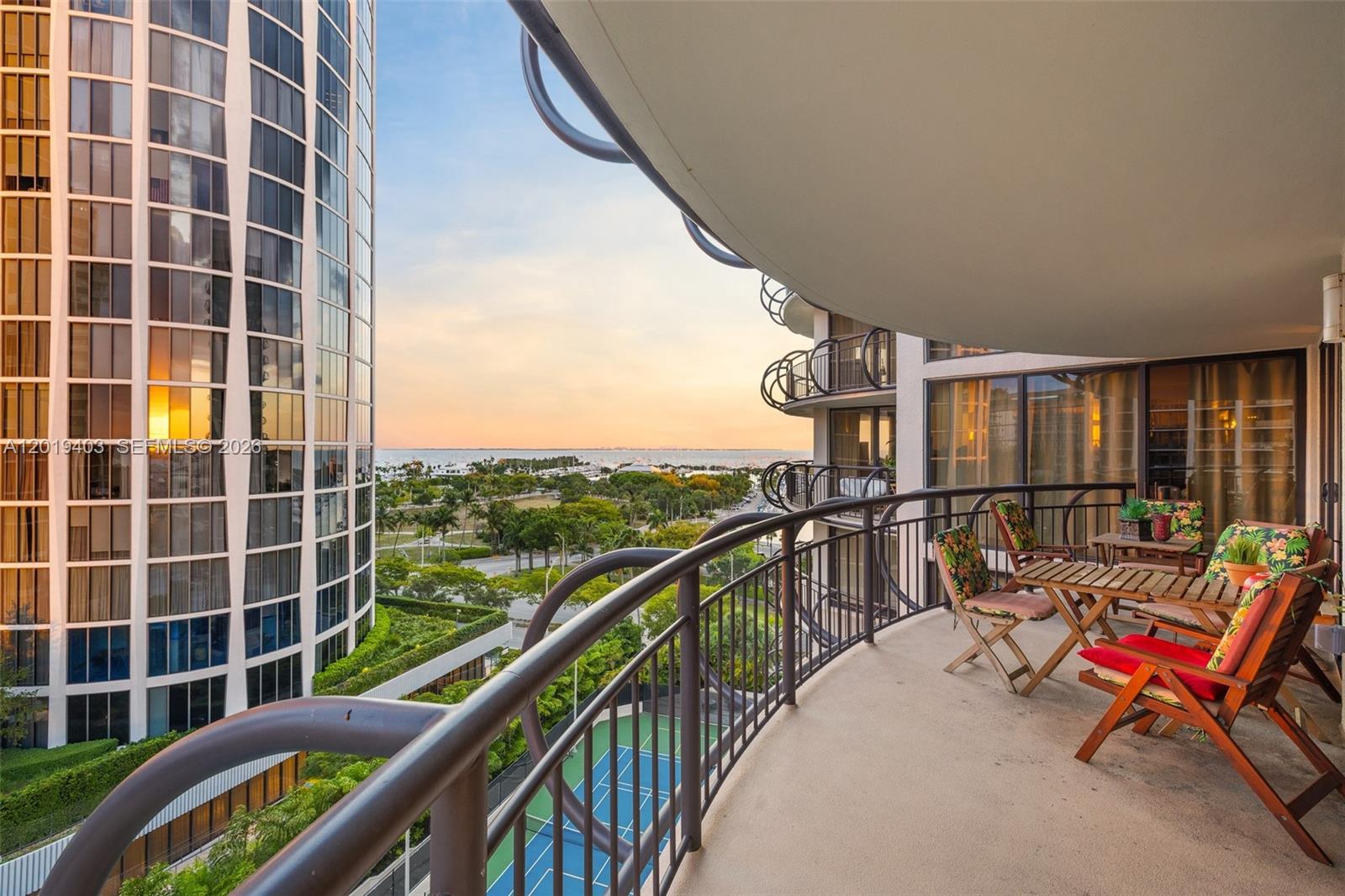 Experience waterfront living in this expansive 3-bedroom, 3-bathroom residence at Grove Towers, showcasing sweeping Biscayne Bay views and stunning sunsets over Coconut Grove. Spanning 1,388 SF, the residence is filled with natural light and features traditional finishes, impact windows and doors, expansive terraces, and a thoughtfully designed layout that enhances the connection between indoor and outdoor spaces. Every bedroom offers direct balcony access, capturing tranquil views of the bay, lush greenery, and tennis courts. The spacious primary suite includes dual vanities, a glass-enclosed shower, and a walk-in closet, while the kitchen features an oversized island designed for entertaining. Residents of Grove Towers enjoy an exceptional collection of amenities including a heated pool and spa, fitness center, tennis and pickleball courts, BBQ area, valet service, and guest parking. Perfectly positioned near the marina, sailing club, waterfront parks, acclaimed dining, cafés, boutiques, and top-rated schools, this home offers an ideal blend of luxury and convenience in the heart of Coconut Grove.