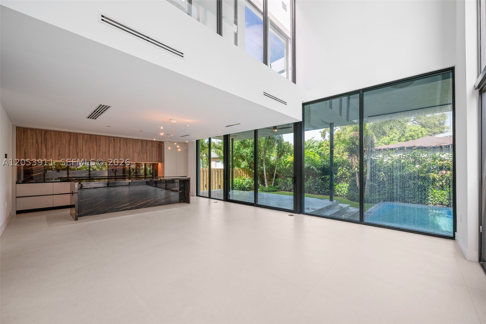 4-bedroom, 4-bath contemporary residence with an air-conditioned garage that can easily serve as a home gym, office, media room, or playroom. This one-of-a-kind home features a truly unique architectural design (not your typical cookie-cutter home) with soaring double-height ceilings in the living room, floor-to-ceiling glass, glass railings, abundant natural light, and lush greenery surrounding the property for exceptional privacy and tranquility. Each bedroom offers its own en-suite bathroom, including a private first-floor guest suite with an independent entrance. Premium Dacor and Miele appliances, porcelain tile flooring, and porcelain finishes in the kitchen and bathrooms elevate the home's modern design, while custom LED accent lighting in the kitchen, bathrooms, and staircase enhances its sophisticated ambiance. The spacious primary suite opens to a private balcony with an open-air jacuzzi, creating the perfect setting to relax under the stars. Enjoy a heated pool with a sun shelf, rain shower, beautifully landscaped outdoor spaces with an irrigation sprinkler system for easy maintenance, and an expansive rooftop terrace ideal for entertaining. An aluminum electric privacy fence is also being installed, adding both security and curb appeal. Located in the heart of Coconut Grove, this exceptional home is within walking distance to the village center, restaurants, cafés, shopping, parks, and marinas, offering the best of luxury indoor-outdoor living.