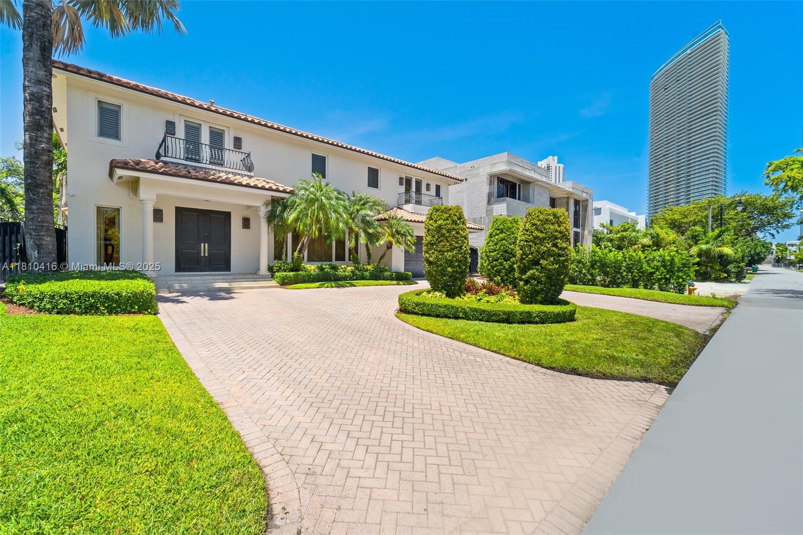 Custom-built home in Golden Shores, just steps from the beach in Sunny Isles. This spacious 6-bedroom, 6.5-bathroom home includes a den that can be a 7th bedroom. An elegance feel with refined finishes throughout. Two bedrooms are located on the ground floor, with the remaining bedrooms—including the primary suite—upstairs. The home features full impact windows and doors, a built-in generator, and great natural light throughout. The open chef’s kitchen offers plenty of cabinet & counter space, ideal for cooking and hosting. Detailed crown molding throughout. Marble and Wood flooring. Covered patio with a built-in grill, a pool area perfect for entertaining, and a low-maintenance yard. Just minutes from high-end restaurants and luxury shopping. A+ School district.