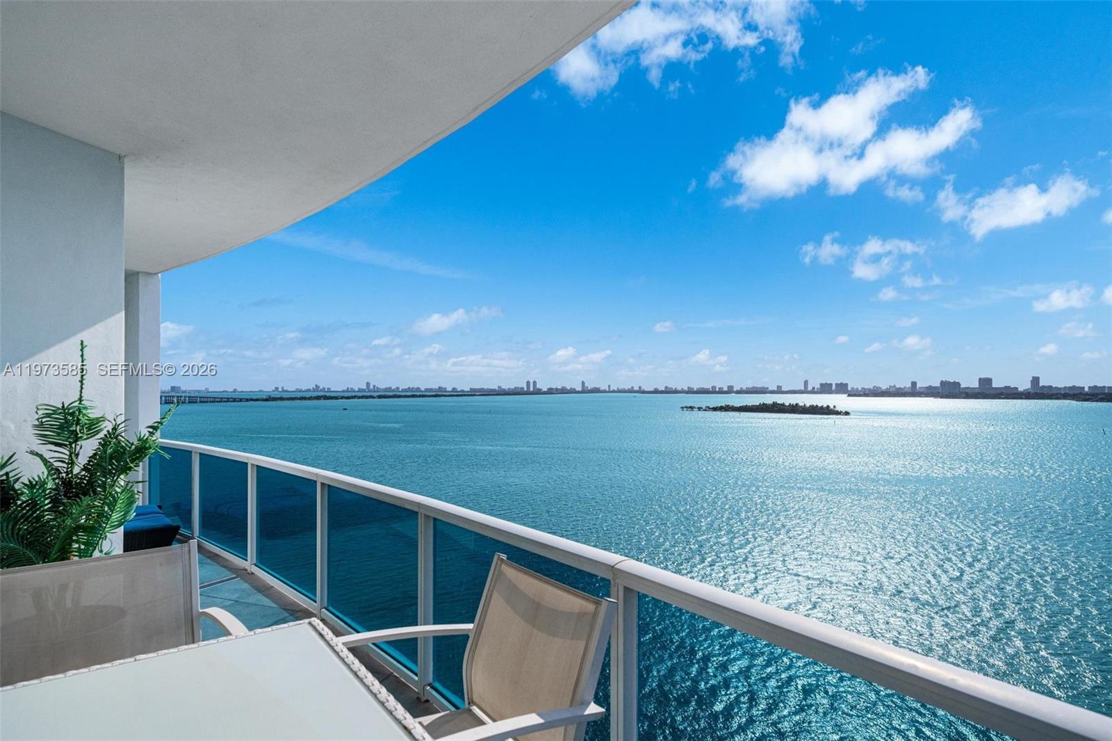 Welcome to this stunning 2BD + den/2BA bayfront residence at the New Wave Condominium, designed by acclaimed architect Kobi Karp. Upon entry, you’re greeted by breathtaking bay and skyline views that fill the home with natural light. The modern kitchen, featuring updated appliances, flows seamlessly into the open living and dining area. The primary suite offers direct terrace access and a spacious bathroom complete with dual vanities and a large walk-in shower. The den can easily be converted into a third bedroom. Amenities include an expansive waterfront pool, a bayfront fitness center, and 24/7 security. Ideally located in the heart of Edgewater, you are just minutes from Downtown Miami, Brickell, Miami Beach, and MIA Airport. With spectacular views and a highly centralized location, this residence offers an exceptional opportunity to experience the best of Miami living. Two parking spaces included.