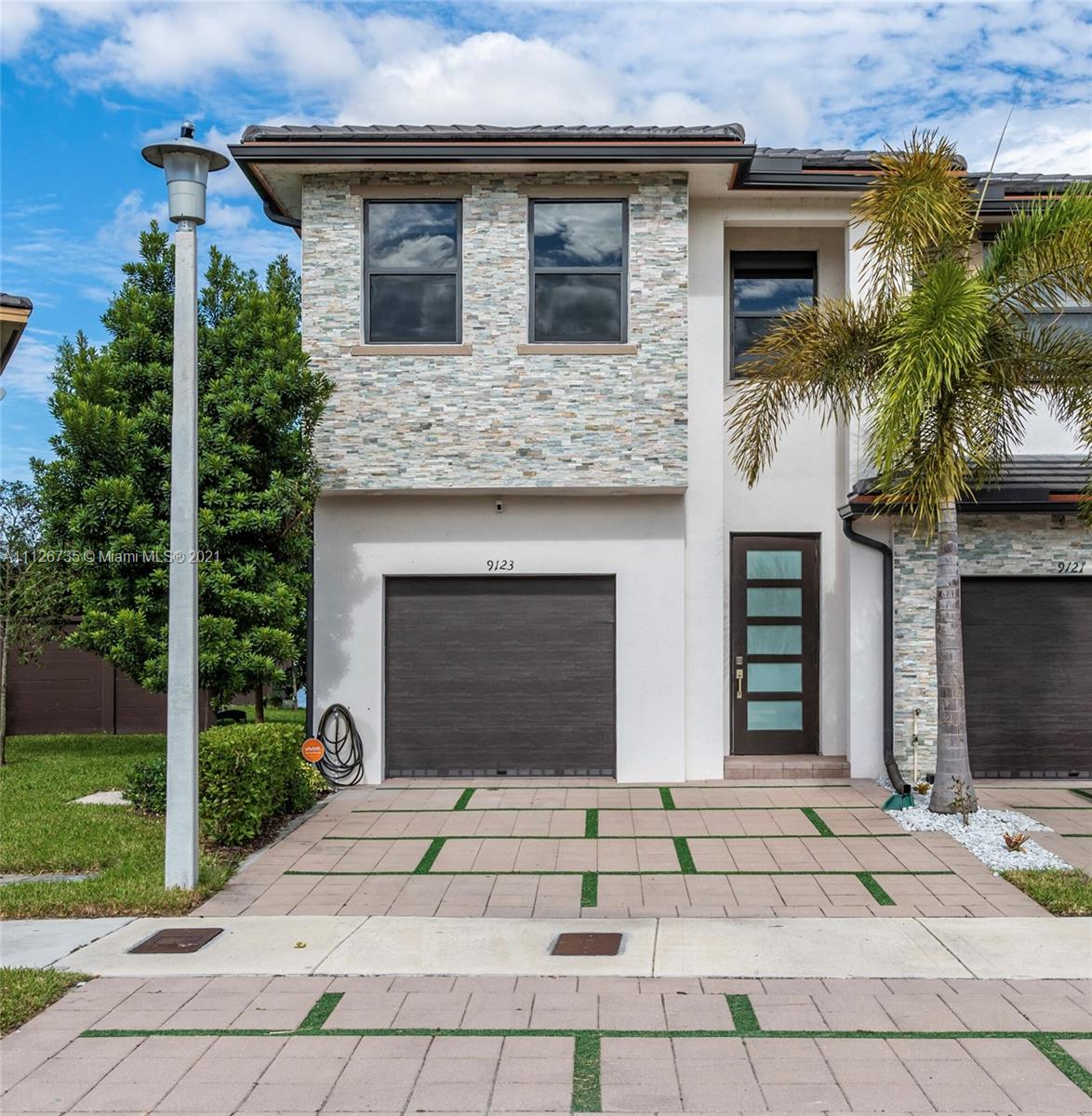 Imagine a glistening 67-acre lake as your backyard. It’s the everyday beauty of life at Satori, a gated Miami Lakes community. The collection of modern townhomes, executive homes, and estate homes embraces the lake, which is framed by a wide paver path, pagodas, a pool, docks, and park benches. This 3BD/3.5BA/1,908 SF lakefront corner residence, which can be easily converted to a 4BD, features an expanded master suite, an oversized kitchen, and a finished patio deck. Enhanced design touches are everywhere, from the porcelain wood-look tile flooring downstairs, luxury vinyl flooring upstairs, and finished garage flooring, to the upgraded stair railing, freshly painted interior, and more. Families love the quick access to the kids’ park. Impact windows and doors. Guest parking.