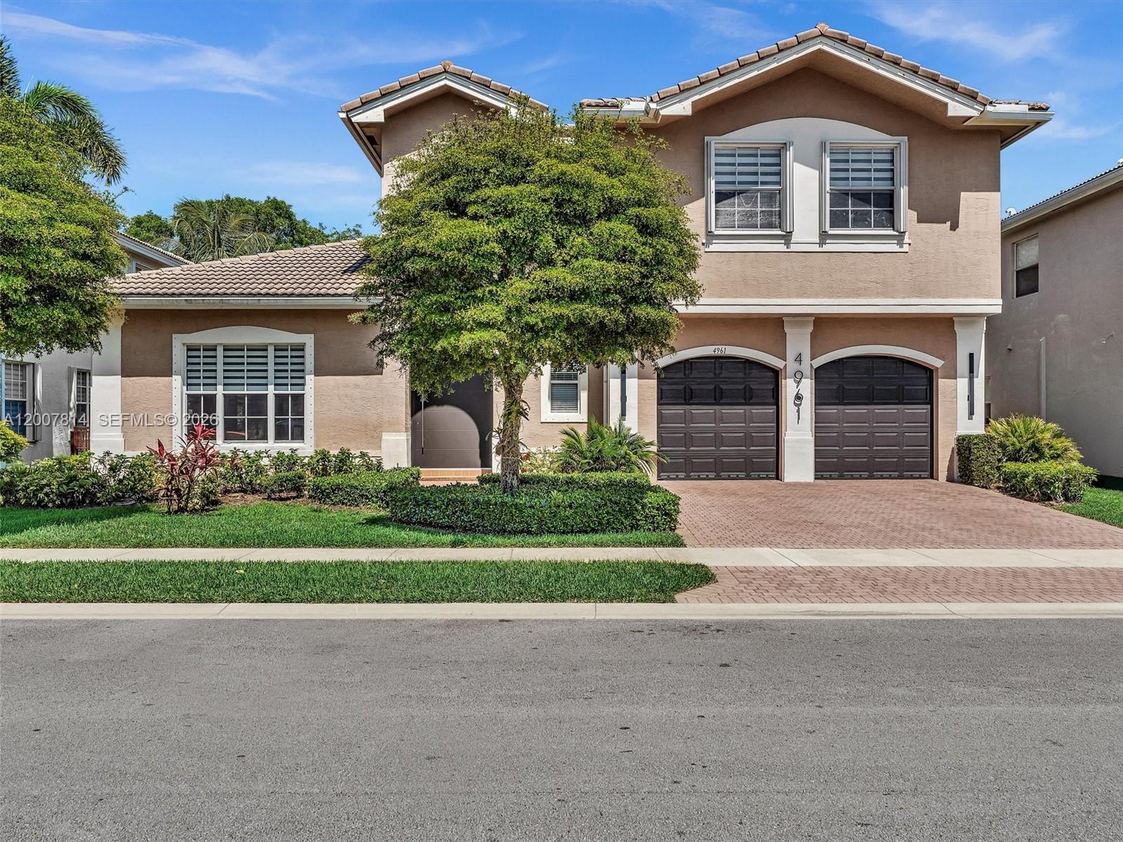 Nestled in the sought-after community of Sunset Falls, this stunning 5-bedroom, 3-bathroom home beautifully blends timeless traditional style with a contemporary flair. Enter through the impressive custom pivot door and immediately experience its grandeur, highlighted by a spacious living room and formal dining area. At the heart of the home, the chef-inspired center island kitchen features rich wood cabinetry, granite countertops, double ovens, a 36-inch cooktop and snack bar, all overlooking the inviting family room accented with stylish wood accent wall. The main level also offers a full bedroom and bathroom, perfect for guests, office or multi-generational living. Ascend the striking glass-railed staircase to the spacious primary suite, complete with custom closets and an ensuite bath featuring dual vanities, a soaking tub and  separate shower. Upstairs, the perfectly designed split-bedroom floor plan includes three additional large bedrooms, each with ample closet space. Step outside to the expansive patio and envision relaxing beside the inviting freeform pool, all surrounded by a fully fenced backyard that backs to a lushly landscaped green space for added privacy. Located within gated community you find resort-style amenities including clubhouse, fitness center, tennis courts, and walking paths. Zoned for top-rated schools and conveniently close to shopping, dining, and major highways, this exceptional home offers the ultimate in Florida living!