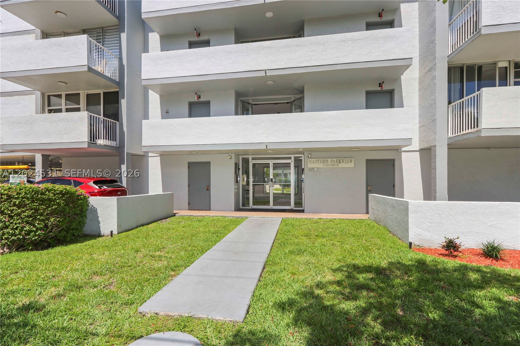 Discover the perfect blend of comfort, convenience, and South Florida living in this bright and spacious 1-bedroom, 1.5-bath residence offering approximately 720 sq ft of thoughtfully designed living space. Ideally located near Sunny Isles Beach, Aventura Mall, shopping, dining, parks, and major highways, this home provides a peaceful retreat while remaining close to everything.

Filled with natural light, the residence features updated wood-style flooring, generous storage, custom built-in shelving, a large walk-in closet, remodeled guest bath, and a private balcony overlooking serene tropical greenery. The functional layout creates an inviting atmosphere designed for both relaxation and productivity.

Whether working remotely, enjoying seasonal living, or seeking a year-round residence, this unit uniquely combines the comfort of home with the convenience and ease often associated with hotel-style living. The spacious layout offers flexibility to create the ideal balance between work, rest, and everyday enjoyment.

Boutique-style building surrounded by lush landscapes and nearby waterways, offering a quiet residential setting with exceptional accessibility. A rare opportunity for a primary residence, vacation escape, or investment opportunity (subject to association guidelines).