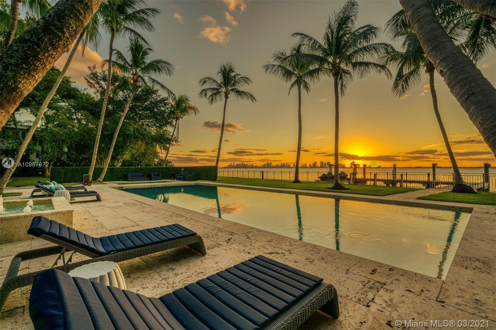 Stunning and historic waterfront Mediterranean revival estate. The 10,769 SF estate is situated on beautiful Biscayne Bay with mesmerizing bay and skyline views. Positioned on a sprawling 52,881 SF lot offering 184’ of WF. A stately gated entry opens to a royal palm forest, gorgeous curved coconut palms & 6,000-gallon koi pond. Evoking the architecture of Spain & Italy w/exquisite arched arcades & covered terraces. Interior beckons w/ a grand 2-story rotunda cupola foyer & 150-year-old reclaimed hardwood, customized chef’s kitchen, enchanting courtyard, principal suite w/ custom-designed walk-in closets & private terrace, wine cellar & elevator. The estate’s exterior boasts a large pool & spa surrounded by a Dominican coral stone deck, a summer kitchen & cabana, & a large private dock.