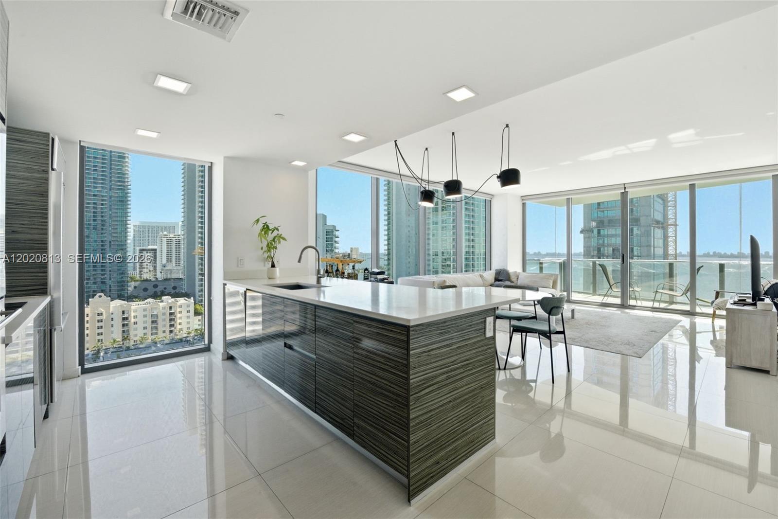 Stunning corner residence featuring 2beds/2baths + den in the highly sought-after Edgewater neighborhood of Miami. This turnkey home offers breathtaking panoramic views of Biscayne Bay and the Miami Beach skyline through expansive windows that fill the space with natural light. The open-concept gourmet eat-in kitchen is beautifully appointed with high-end appliances, sleek finishes, and ample space for entertaining. Spacious bedrooms offer generous closet space, while the inviting living area creates the perfect setting to relax and enjoy the spectacular waterfront scenery. Residents enjoy resort-style amenities including an infinity-edge bayfront pool, state-of-the-art fitness center, spa, clubroom, theater room, and two tennis courts. Ideally located just minutes from the Miami Design District, Arts & Entertainment District, and Wynwood, with convenient access to South Beach (10 minutes), Brickell (15 minutes), and Miami International Airport (5 minutes)