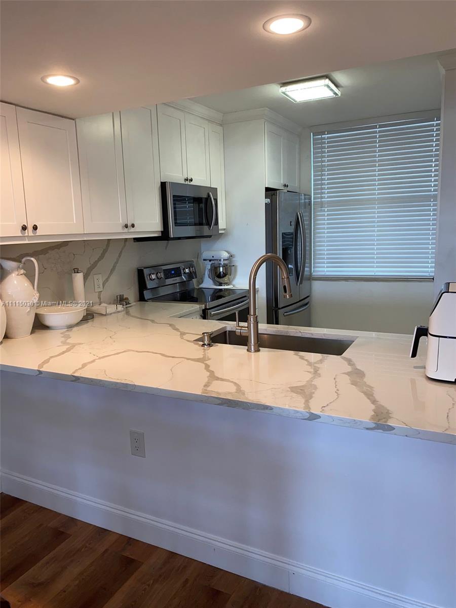 IMMACULATE FULLY RENOVATED 2 BED 2 BATH TOP FLOOR CORNER UNIT TURN KEY BEAUTY! BEST AMAZING VIEWS OF SUNSETS AND IS NESTLED IN THE HEART OF MOST SOUGHT AFTER COMMUNITY IN PINE ISLAND RIDGE. THERE'S A LAUNDRY AND BONUS ROOM WHICH CAN BE USED AS GUEST BEDROOM, PLAY,  WORKOUT, HOME OFFICE OR FOR EXTRA STORAGE. THIS HOME HAS A BRAND NEW WATER HEATER AND IS FULLY EQUIPPED WITH LOW E IMPACT WINDOWS. EXCELLENT SCHOOL ZONE FOR ALL GRADES. WALKING. DISTANCE TO SUPERMARKET, SHOPS, RESTAURANTS AND MAJOR HIGHWAYS. AS A UNIT OWNER YOU HAVE ACCESS AND MEMBERSHIP TO THE COUNTRY CLUB OF PINE ISLAND RIDGE. GOLF, TENNIS, BASKETBALL, SWIMMING POOL WITH HOT TUB, SAUNA AND TWO RESTAURANTS AWAIT YOU! THIS WILL NOT LAST. OPEN HOUSE AND FIRST LOOK THIS SUNDAY OCTOBER 24 FROM 1-3 PM CALL LISTING AGENT FOR DETAILS.