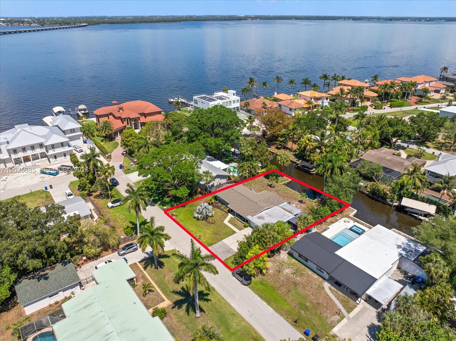Welcome to 1229 Carlene Ave, a rare riverfront opportunity in Fort Myers where breathtaking water views, boating access, and the relaxed Florida lifestyle come together. Set along the scenic Caloosahatchee River, this charming 3-bedroom, 2.5-bath home offers waterfront living with easy access to the world-renowned beaches and island destinations of Sanibel Island and Captiva Island. Designed for enjoying life on the water, the property features a private 16x42 boat basin with direct access to the Gulf, ideal for boating enthusiasts, fishing adventures, and sunset cruises. Spend your mornings watching dolphins play past the dock and manatees gathering nearby, afternoons kayaking or paddleboarding through scenic waterways, and evenings entertaining against a backdrop of spectacular river sunsets. The waterfront lot also offers ample room to design and build your dream pool. Conveniently located near Downtown Fort Myers, you’ll enjoy access to waterfront dining, shopping, marinas, entertainment, and cultural attractions. Whether you are searching for a full-time residence, seasonal getaway, or waterfront investment opportunity, this property offers a combination of location, lifestyle, and waterfront charm. This home blends comfort & character with timeless terrazzo flooring, an updated kitchen, and an ADA-accessible bathroom. Move-in ready and filled with coastal charm, this is your opportunity to experience the beauty, tranquility, and adventure of Florida waterfront living.
