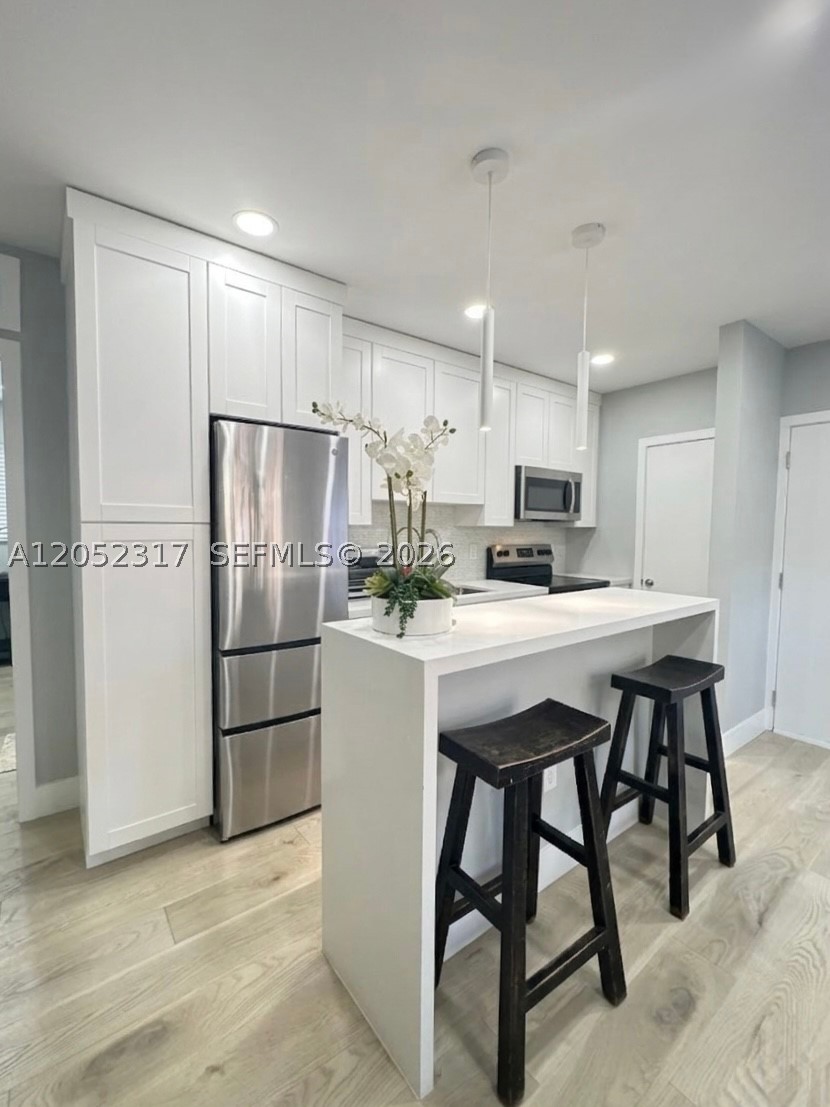 Experience the "Hidden Jewel" of South Miami! Tucked away on an exclusive private street, these chic, fully remodeled 1/1 condos on the 1st floor offer a serene tropical oasis. Various units available, starting at $2,000-$2,400/mo unfurnished. This specific unit is the only one offered fully furnished and equipped at $2,500-$2,900/mo, depending on lease terms. Each home boasts a bright 550 SF open layout with lush garden views, premium wood-like floors, elegant white shaker cabinets, a kitchen island with white quartz, a spacious built-in closet, and a luxury bath with glass shower doors. Enjoy this furnished unit, the only unit with the convenience of a dedicated indoor laundry room right inside your unit. Exclusively, this furnished unit features a smart security door lock-bell-camera, a massive 75" TV, an ultra-comfortable L-shaped sectional couch, a coffee table with pullout trays, and a kitchen fully stocked with cookware, an air fryer, a blender, plates, glasses, pots, pans, and even baking pots. Perfect for students or relocating professionals. Walk to downtown South Miami, Sunset Place shops, South Miami Hspt, the MetroRail, Larkin/Ross University, and minutes to the University of Miami. Monthly rent includes water, gas, trash removal, and 1 assigned parking space. Enjoy rare short-term leasing flexibility. Optional premium "plug-and-play" upgrades can bundle electric, high-speed internet, and monthly professional cleaning. Pet-friendly and absolutely move-in ready!