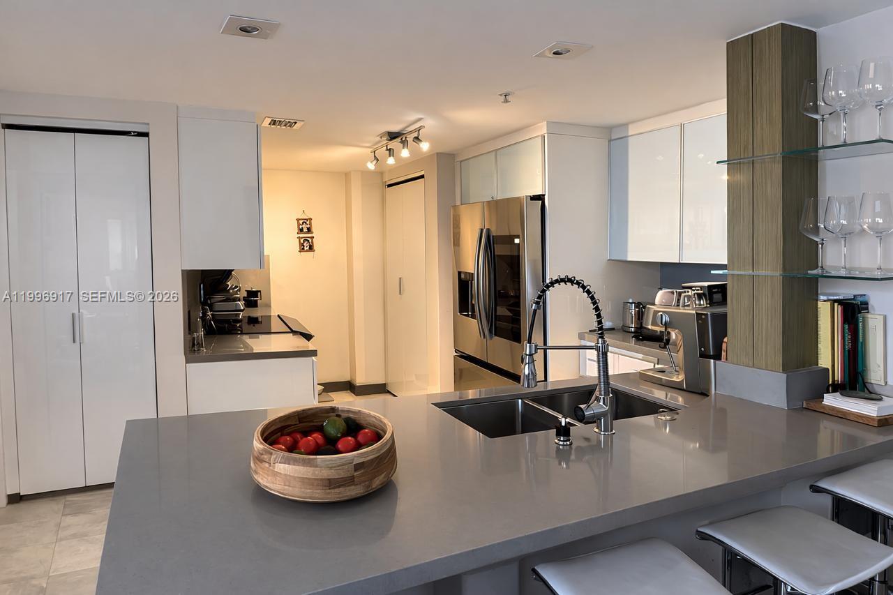 Spectacular modern residence — a must see! Completely renovated designer unit with amazing views from this beautiful 2-bedroom, 2-bath split floor plan at Courvoisier Courts on exclusive Brickell Key. Features include elegant marble floors, stainless steel appliances, quartz countertops in the kitchen and bathrooms, custom closets, and built-in speakers throughout. Condo Fees $1689 monthly and $1066 yearly for the Island Maintenance. Enjoy resort-style living in this full-service building with amenities including a two-story fitness center, squash court, billiards room, swimming pool, sauna, and outdoor jacuzzi. Additional features include a brand-new business center, BBQ area with water views, Amazon lockers, an on-site convenience store, facial recognition security system, 24-hour security and concierge, and guest valet service available 7 days a week.
