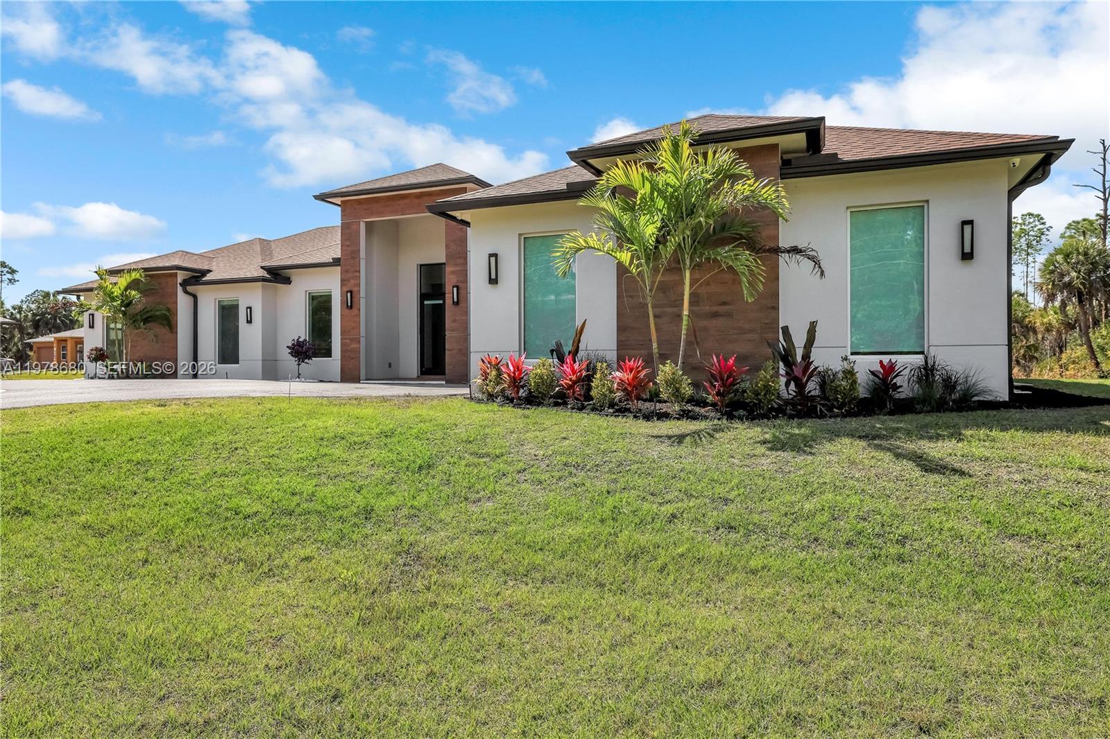 Set on 2.81 acres, 2023 new construction property thoughtfully designed residence offers 3 bedrooms, 4 bathrooms, and 3 versatile den/flex rooms, allowing the home to adapt to any lifestyle needs. The home features two spacious junior suites, each with its own private full bathroom. The primary suite is privately positioned on the opposite side of the home. Comfort was carefully planned with two independent AC systems, allowing the guest wing and primary suite to operate on separate thermostats for optimal climate control.
Designed with flexibility in mind, the property includes three additional den rooms that can easily serve as home offices. A versatile area within the garage also offers potential for a home gym, mother-in-law suite, or climate-controlled storage.
At the heart of the home is a custom marble island kitchen equipped with high-end appliances, including a 48-inch Wolf gas range, creating the perfect setting for cooking and entertaining. Enjoy your favorite music through built-in ceiling speakers in the great room, primary bedroom, and lanai, while effortlessly controlling blackout shades with the touch of a remote. The home features tile floor throughout, natural wood master bed, and impact windows. 
The property is ready with an electrical subpanel for a future pool, generator, or solar panels.
This is the kind of home that offers room to grow, room to host, and room to breathe, where the possibilities extend far beyond the walls of the house.