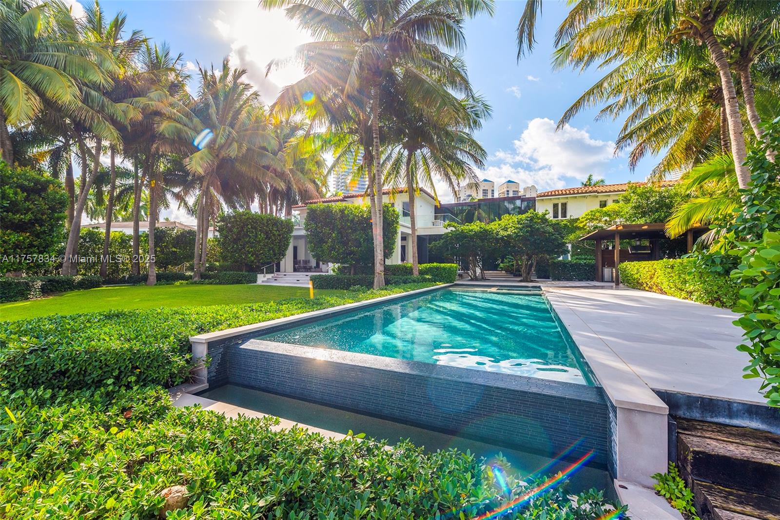 Welcome to the epitome of luxury and privacy in Golden Beach: a sprawling 26,000 sqft waterfront estate featuring a bespoke 8,000+ sqft home. Unmatched in its grandeur, this one-of-a-kind property, which was fully renovated in 2017, offers a 6-bedroom masterpiece that includes an office and service room. Concealed behind majestic hedged walls, tranquility reigns in this immaculate, custom-designed paradise. Every turnkey room reflects sleek design and meticulous attention to detail. Embrace serenity in the massive backyard with a private deep-water 120 Feet dock optimal for yacht owners. Perfect for families, its prime location is steps from a private beach, nine charming parks, tennis courts, and a forthcoming wellness center, making it an unrivaled haven in Golden Beach