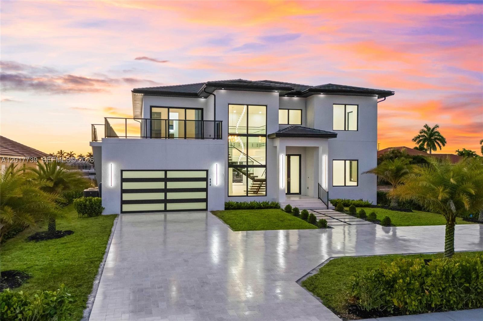 Newly constructed in 2026, this Gulf-access custom two story waterfront estate offers 6 bedrooms plus a den, 6.5 bathrooms, lake views, and resort style indoor-outdoor living. Set on an oversized homesite, the home features contemporary architecture, water views, and space for luxury living, entertaining, multigenerational use, or vacation rental potential. The outdoor area is a private resort with an infinity-edge saltwater pool, jacuzzi spa, bubblers, water shelf, spacious lanai, glass pool enclosure, pool bath, and Paradise outdoor kitchen with gas grill and refrigerator. Limestone pavers and custom landscaping complete the setting. Inside, the open concept layout offers soaring ceilings, glass railings, natural light, and California-style sliders to the waterfront. The gourmet kitchen includes Thermador appliances, gas cooktop, panel refrigerator, double oven, dishwasher, built-in microwave, enclosed wine cabinet, Taj Mahal quartzite countertops, custom cabinetry, designer lighting, pantry, and laundry room. Finishes include European-style doors, custom closets, Hansgrohe fixtures, smart toilets, and designer bathrooms. The ground-level primary suite offers a spa inspired wet room with soaking tub and walk-in shower, dual vanities, and private water closet with bidet. Guest suites and flex spaces provide comfort and privacy. Epoxied garage floors, circular driveway, modern finishes, and Gulf access boating complete this rare Cape Coral waterfront opportunity.
