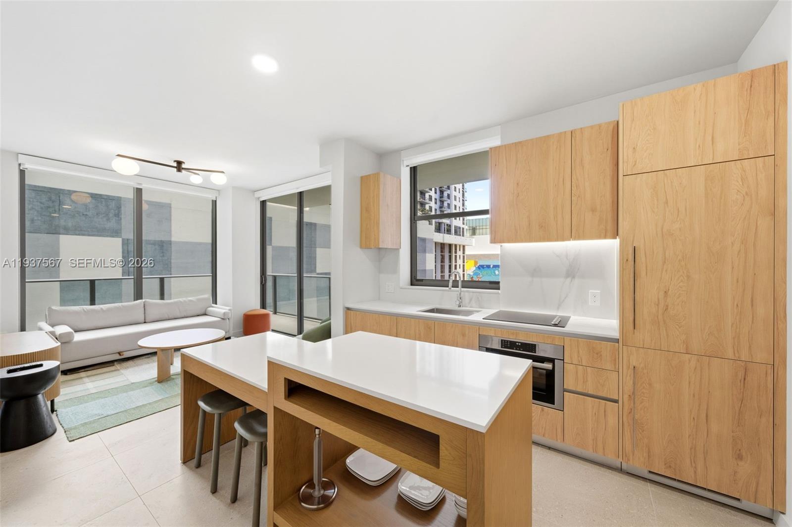 Ideally positioned in the heart of Miami Worldcenter, this fully furnished corner two-bedroom residence at The Crosby offers a rare turnkey opportunity with no rental restrictions, making it equally suited for full-time living or short-term rental income. Spanning nearly 1,000 total square feet, the thoughtfully designed layout is enhanced by corner exposure and floor-to-ceiling glass that fills the interiors with natural light. European porcelain flooring runs throughout the residence, complementing the contemporary furnishings and custom built-out cabinetry. The open kitchen features sleek Italian cabinetry paired with a full suite of Bosch appliances, creating a refined yet functional space for everyday living and entertaining. Both bedrooms offer generous proportions and built-out closets, while spa-inspired bathrooms showcase modern finishes and rain showers. A full-size washer and dryer and smart-home technology add everyday convenience. Residents enjoy access to over 22,000 square feet of resort-style amenities including a rooftop pool with cabanas, private restaurant and bar, fitness center with saunas and plunge pools, coworking spaces and 24/7 concierge services. Located moments from Museum Park, dining, entertainment, and the Brightline, this residence delivers exceptional lifestyle appeal and strong investment potential in one of Downtown Miami’s most dynamic neighborhoods.