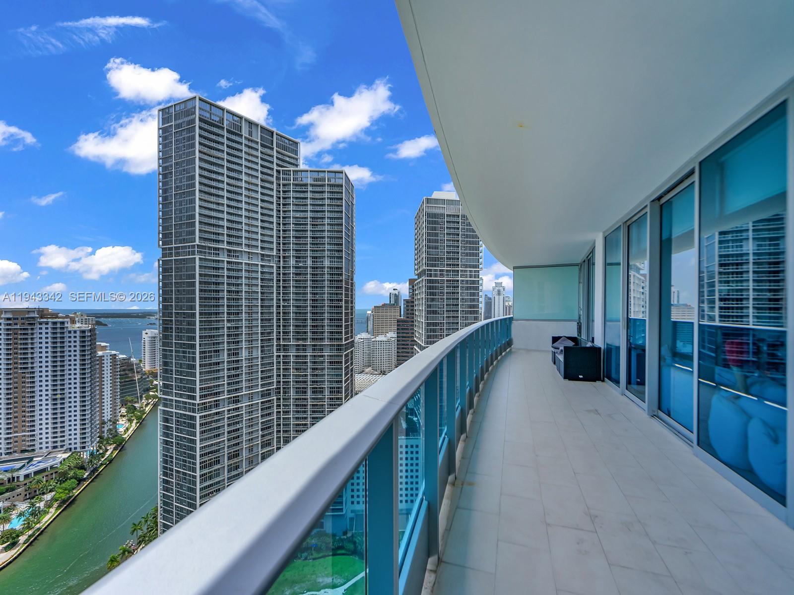 Stunning view of the bay and the city from this 2 bedroom and 2 full bath and half. 11 ft ceilings and porcelain white floors. Split floor plan with large bedrooms. Beautiful master bathroom with separate whirpool tub & shower, dual sinks. Large modern kitchen with Miele appliances. Bosch Washer & Dryer in unit. 1 covered parking space plus valet.  Experience the best of Miami luxury living — just steps away from Brickell, Bayside, Whole Foods, and all the city’s top dining and nightlife. Amazing view ot the Miami River, Fisher Island, Brickell and South Beach.