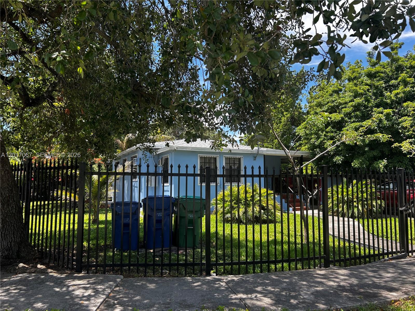 Excellent location for this big corner lot investment property. House can be easily converted into a 2/2 for Owner occupied. Washer and Dryer located in the back porch with a new Roof, Recently Painted, Gated home with permitted efficiency with own entrance. Needs a bit of TLC. Tile Throughout. The 1/1 has separate entrance. Excellent location near MIA. Conveniently located close to shopping and not too far from downtown Miami and major Hwys (836/826) Must see, excellent investment return. Make our appoint today.