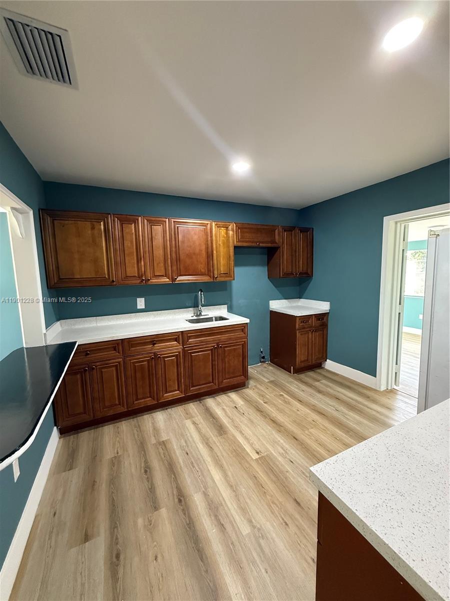 Great investment opportunity! This property sits high and dry with excellent access to Indian River and St. Lucie Counties. Just minutes from the beach, shopping, and main roads. Features a spacious backyard ideal for BBQs or an outdoor kitchen, new laminated floors, fully remodeled bathroom, new  AC, and renovated entry and bedrooms. Includes a double-sided closet with connections and plenty of storage. Perfect potential for an outdoor grill or picnic area — move-in ready and full of charm!