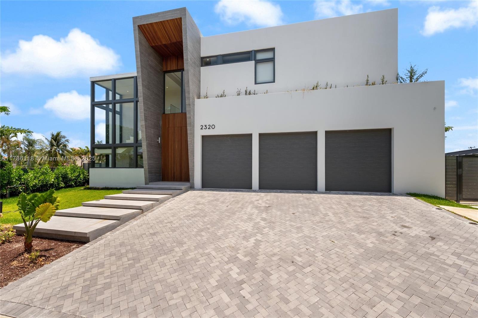 Welcome to a breathtaking waterfront masterpiece at 2320 LHP, completed in fall 2024. This home radiates modern elegance and luxury, nestled in a prime canal front location. The home boasts 5 spacious en-suite bedrooms, an office, and 6 bathrooms, including a full cabana bath, all adorned with Italian cabinetry for a seamless blend of style and functionality. The open space layout features a kitchen equipped with top-of-the-line appliances, perfect for culinary enthusiasts. Enjoy 80 feet of waterfront with a private boat dock, granting direct access to tranquil waters. The outdoor space is an entertainer's dream, featuring a charming pool, hot tub, and captivating water views. Inside, a private elevator ensures effortless access to all levels. A rare opportunity to own a slice of paradise