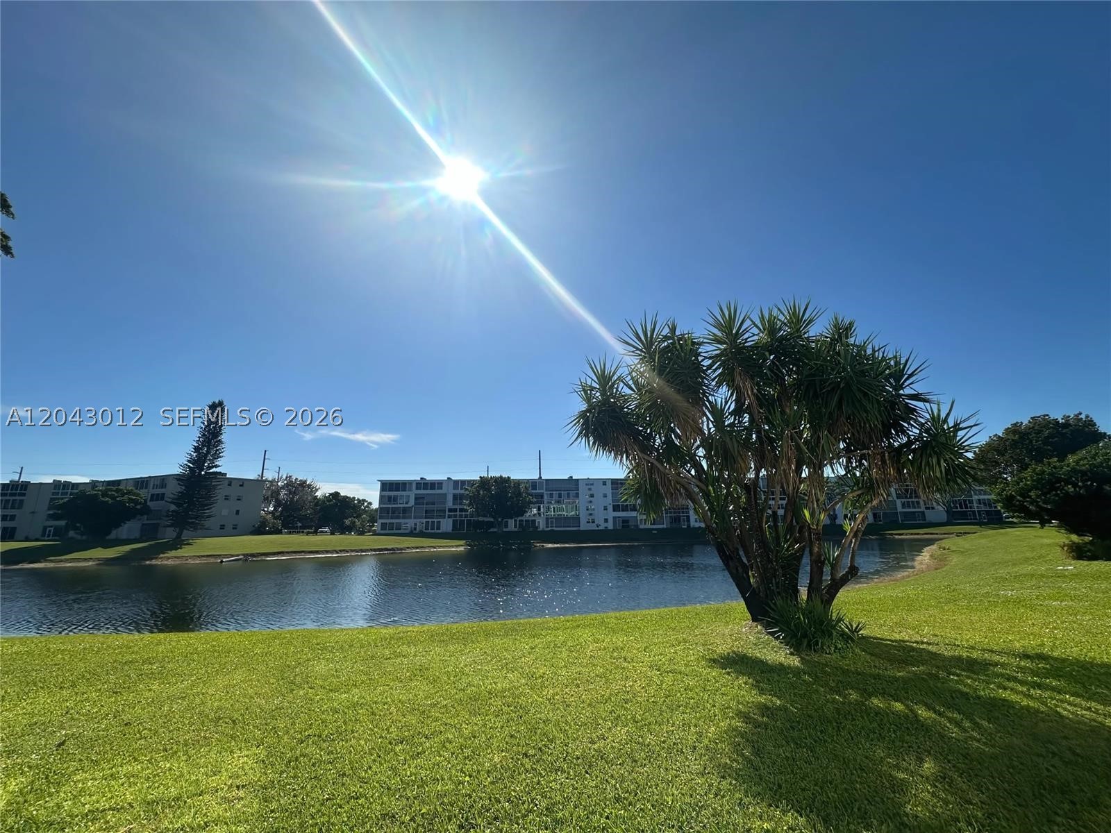 GORGEOUS WATER VIEW! Experience a perfect blend of comfort & convenience in this cozy 1ST FLOOR 1 bedroom, 1 bath condo w/pkg in front! FULLY FURNISHED & ready for you to enjoy Florida living at it's best! Updated OPEN KIT features white appl, extra cab & tile cntrs & backsplash! Tile & lam flrs, crown molding in liv areas, new water heater & an updated bathroom w/tub/shower & glass shower doors are more wonderful upgrades! Enjoy a breathtaking lake view from your lg encl patio! Well maintained bldg. w/NEW ROOF! Community BBQ area to entertain guests. Enjoy resort style liv in this gated comm w/24 hr sec, amenities galore incl. pools, tennis, pickleball, putting green, shuffleboard, Clubhouse w/cafe, billiards, gym, classes, clubs, movies, shows & MORE! THIS WILL NOT LAST! Assoc Claims 55+