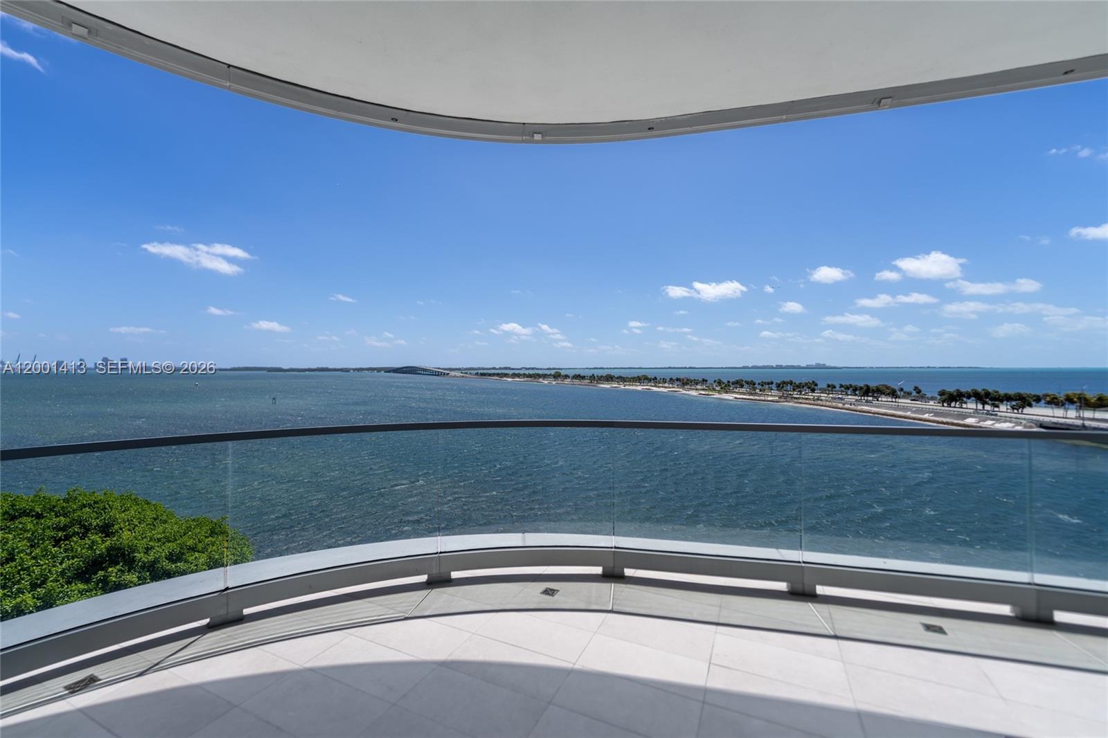 Experience elevated waterfront living at Una Residences. This exceptional 3 Beds/3.5 Baths residence offers breathtaking, unobstructed views of Biscayne Bay and the Atlantic Ocean with dramatic floor-to-ceiling windows in the living area, filling the home with natural light and showcasing spectacular sunrise vistas.Thoughtfully conceived with refined elegance, the residence is adorned with prime natural wood throughout the living areas, creating an atmosphere of warmth, texture, and timeless organic sophistication. The primary bath is appointed with luxurious Calacatta finishes, including a striking Calacatta mosaic floor in the shower. The powder room features sophisticated Vanilish Pear flooring, while the secondary bathrooms are finished with exquisite Bianco Neve mosaic floors. The gourmet kitchen is equipped with premium Gaggenau appliances seamlessly blending performance and cutting-edge design.Developed by OKO Group, led by Vlad Doronin, in collaboration with world-renowned architects Adrian Smith and Gordon Gill, and masterfully landscaped by Enzo Enea, Una Residences sets a new benchmark for boutique luxury living.Residents enjoy an exceptional suite of resort-style amenities, including three swimming pools, a full-service spa, state-of-the-art fitness center, private screening room, and a children’s playground—thoughtfully designed to provide both relaxation and recreation in a serene bayfront setting.