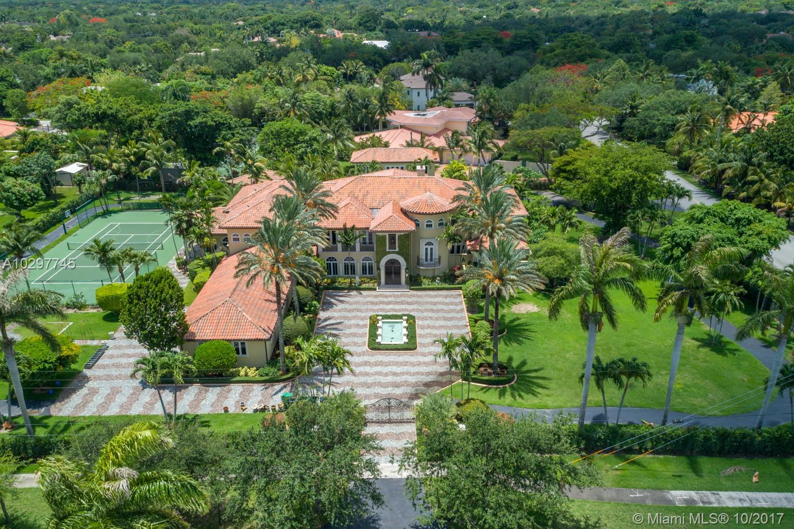 Dream Estate by Robert Wade, 2002 on gated, corner 1.8 acres.Grand and functional, for over the top entertaining and daily enjoyment of indoor/outdoor amenities.High ceilings, luxurious finishes complement large living and entertaining spaces.Custom wood built-in(s) grace the exec office & family rm w/built in bar,aquarium.A custom iron work door opens to the walk in wine rm. The living rm,family rm & kitchen all open to the large covered terrace,lagoon pool and pavilion/guest house.A billiards/play room opens to the NS tennis and bb courts.Downstairs guest suite open to the pool.The grand master suite occupies its own wing. 4 generous bedroom suites share an additional upstairs family/media.Large motorcourt/side drive,4 car gar. A run/walk track surrounds the property. 2/1 staff room.