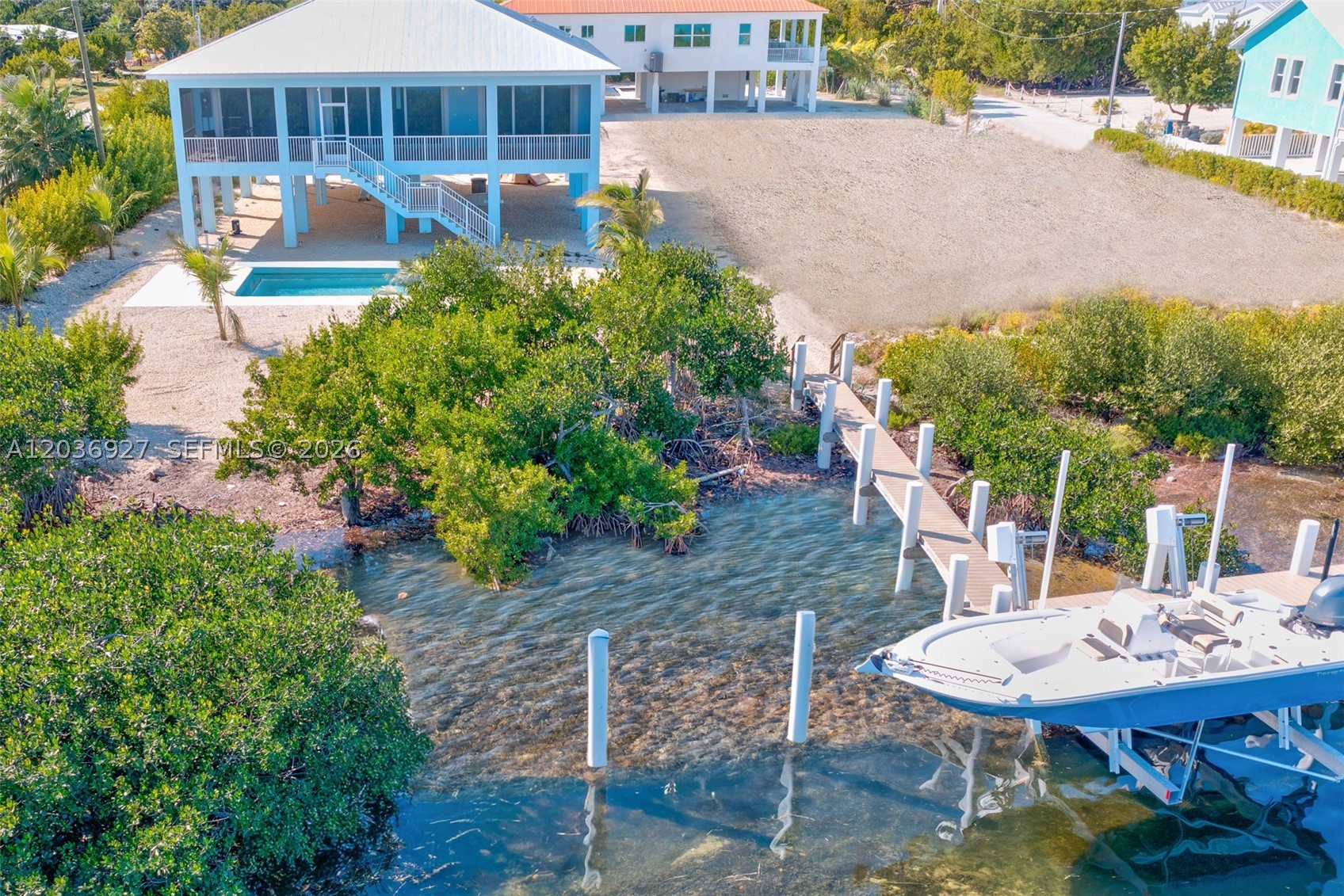 Brand-New Waterfront Home - Completed and Move-In Ready. This elevated CBS single-level residence offers 4 bedrooms, 3 bathrooms, 10-foot ceilings, impact-rated windows and doors, metal roof, stainless steel appliances, quartz countertops, open-concept living, screened porch, private pool, and covered parking below. Built for coastal living, the CBS structure, impact openings, elevated design, and metal roof provide durability, strength, and insurance-friendly features. Allocated dockage includes an approx. 45' access walk to a 91' platform, creating a great setup for boating, kayaking, paddleboarding, and waterfront views. Set on a 14,680-square-foot lot with approx. 75' of waterfront frontage, the property captures panoramic Bay/Gulf-front water views and sunrise exposure. Enjoy access via Bogie Channel, with backcountry access and fast open-water routes to the Atlantic Ocean and the Gulf. Nearby Looe Key Reef is a favorite for snorkeling and scuba diving. Located on the Big Pine Key side of the Bogie Channel Bridge to No Name Key, this setting offers water views and island privacy. The property can be used as an investment property for vacation rental use, adding flexibility and income appeal. Near the iconic No Name Pub and surrounded by the natural beauty of Big Pine Key, where Key Deer are part of everyday island life. Big Pine Key offers conveniences nearby, while still delivering a quiet waterfront lifestyle. Construction is complete and ready for immediate occupancy.