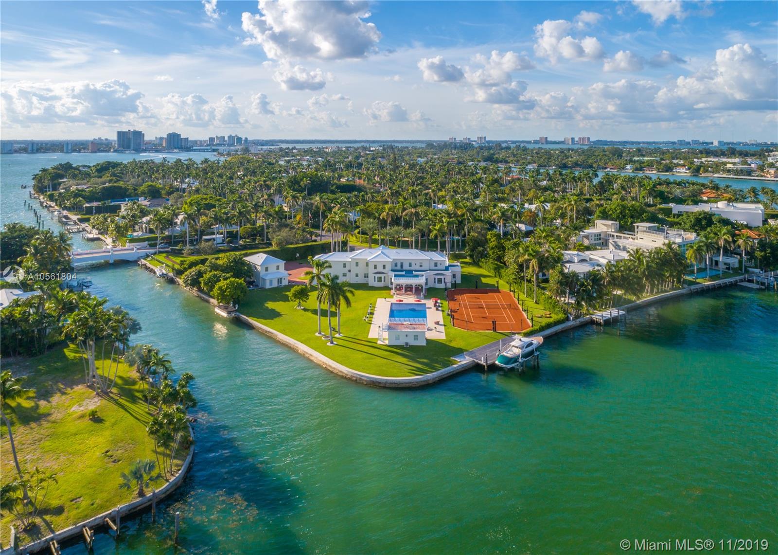 Best price per SF of land on gated island! Tree lined canopied driveway lead you to this premiere La Gorce Island estate showcasing classic & modern design in coveted Miami Beach location. This rare residence has nearly 2 acres of land & 500ft+ of water-frontage & offers easy access to Ocean, Intracoastal & no fixed bridges to the Bay. The 12,687 total sq. ft. residence offers an ideal floorplan for entertaining w/7 bdrms & 9.5 ensuite baths, 950SF custom chefs kitchen & guest wing. Main living area open to covered terrace & enviable outdoor space is highlighted by the gorgeous pool & spacious patios, spa & wading area. Grounds feature separate guest house, gym + pool house w/full kitchen, bath & rooftop deck. Professionally lit Hydro Tennis Crt, 2 boat lifts + newer seawall. 3 car garage.