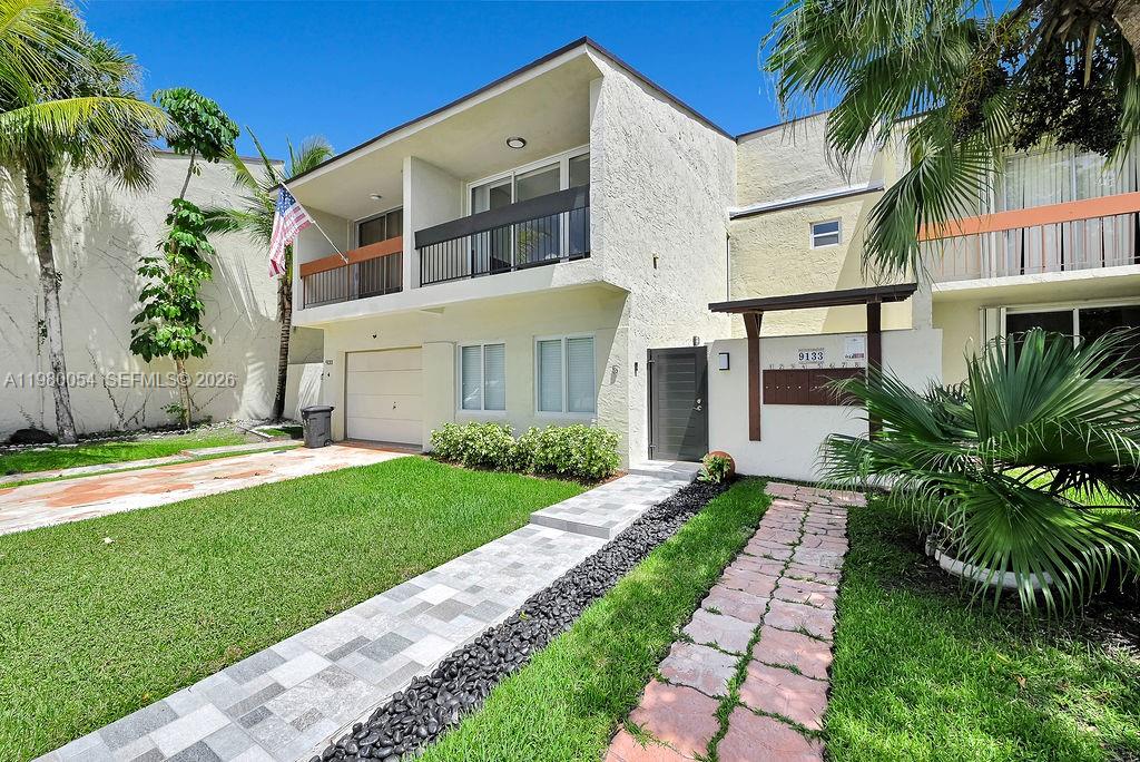 Welcome to this beautifully renovated townhome offering stylish, comfortable living in a peaceful and serene neighborhood. The interior features a modern kitchen with quartz countertops, white shaker cabinetry, stainless steel appliances, and updated contemporary lighting. The open concept living space flows seamlessly to a spacious patio, perfect for entertaining or relaxing outdoors. One generously sized bedroom and full bathroom are conveniently located on the first floor. Upstairs, the remaining bedrooms each offer private balconies, ample closet space, and tastefully updated bathrooms with sleek tile finishes and glass-enclosed showers. Bright and inviting throughout, the home also includes hurricane impact windows for added peace of mind, along with a newly installed roof. The community has been recently repainted and offers assigned parking along with access to amenities. Ideally located near major highways, this home delivers the perfect combination of comfort, style, and convenience.