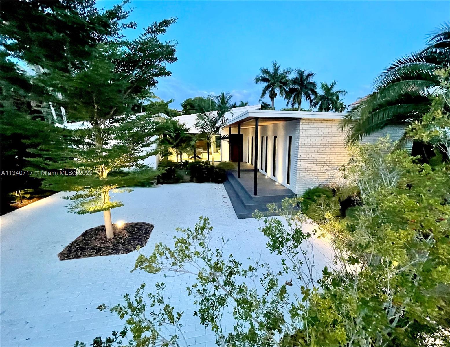 Recently completed Mid-Century Modern. This securely gated modern beach home features elevated finishes throughout including Italian flooring, leathered granite counters, terrazzo marble island, integrated sinks, Miele appliances including 102 bottle wine cooler, ESW windows and doors, Brizo fixtures, Porro Italia cabinetry & closets and much more. The floor to ceiling glass opens up into a private covered outdoor living experience surrounded by the salt water pool and a lush tropical landscape. The pool and backyard were raised to the level of the main living floor for better flood protection and better visibility from inside of the home. One of the lowest $/sq foot for a home of this caliber in Miami Beach.