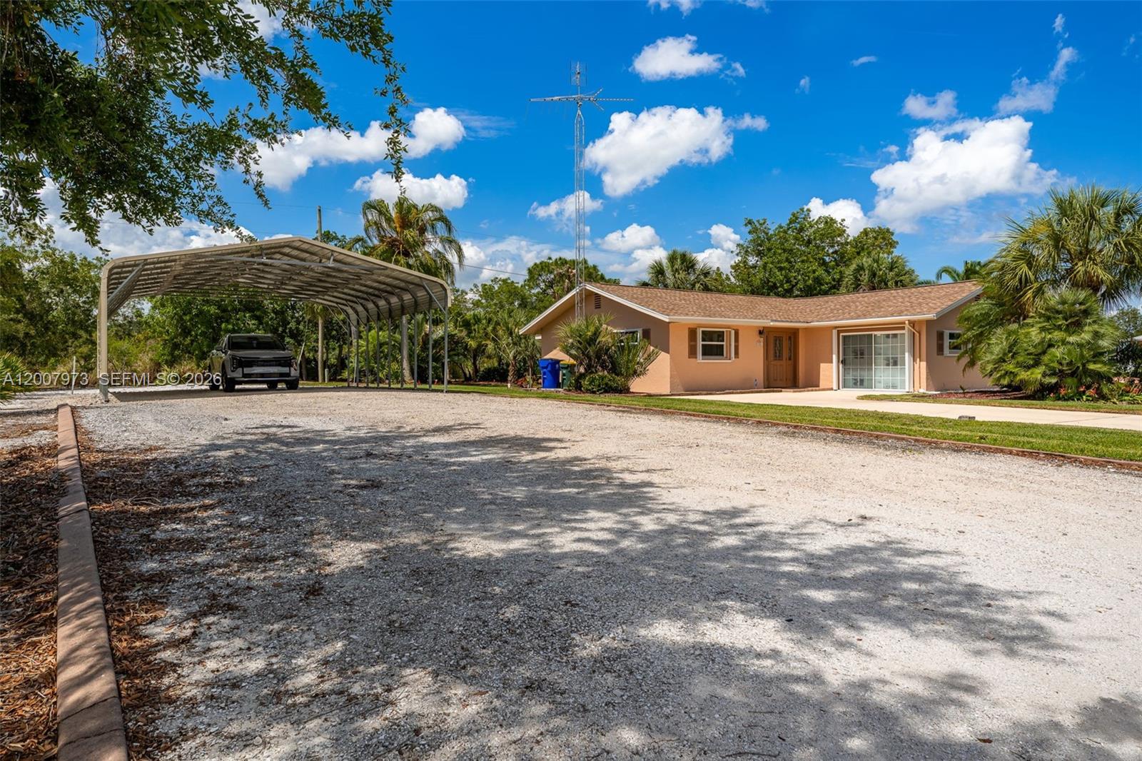 This well maintained home is located in the tranquil town of Lake Placid, FL. on a DOUBLE LOT, that provides room for all your toys. The neighborhood of Placid Lakes provides municipal water to its residents and Lake June  community park is nearby to enjoy fishing, boat ramp and water sports, of Lake June. One of the prettiest lakes around!   Lush landscaping in the front and backyard of the home, with a sprinkler system to keep it green and a walk-in shed for storage for all your tools and gardening equipment. You have plenty of room to start your own vegetable  garden, or add a pool!   There is a  large carport pole barn that has room for your RV and a vehicle or your boat.  The front converted garage can easily be converted to a bedroom with room for an office, or a large office/game room. Inside laundry, tiled floors, split bedroom plan and a galley kitchen w/ a Florida room right off of the kitchen.  Recent updates to the home include a new AC in 2026, roof replacement in 2024, a new drainfield in 2025, septic tank pumped in 2025, a new on-demand hot water heater installed in 2024. The home provides easy to close Hurricane Shutters on all of the windows and a full house generator hook-up, including the generator, so you are ready for any storm issues that come along. Lake Placid is located just 15 South of Sebring, FL and 1.5 hours from Fort Myers, FL or Sarasota, FL Grab a piece of paradise today in sunny Lake Placid
