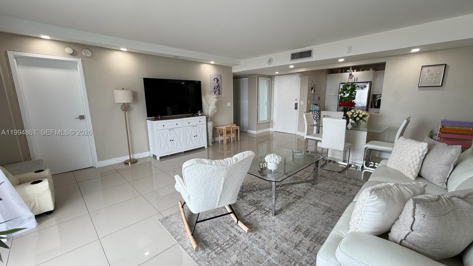 Enjoy the spacious balcony featuring views of the city, the ocean, and the surrounding parks. The kitchen—spacious, bright, modern, and elegant—is ideal for those who value functionality; the unit boasts new flooring and has been beautifully renovated. It is conveniently located just minutes away from shops and parks—such as Oleta River Park and Haulover Park—as well as neighboring communities like Bal Harbour and Sans Souci. Surfside Beach and Sunny Isles are just a 5 to 15-minute drive away, with a wealth of dining options nearby and major retailers like Costco and Target just minutes away. The unit is situated in an area where urban amenities are close at hand, lush green parks are just steps away, and both the FIU International University and Wolfe International University campuses are a mere 9-minute drive away.