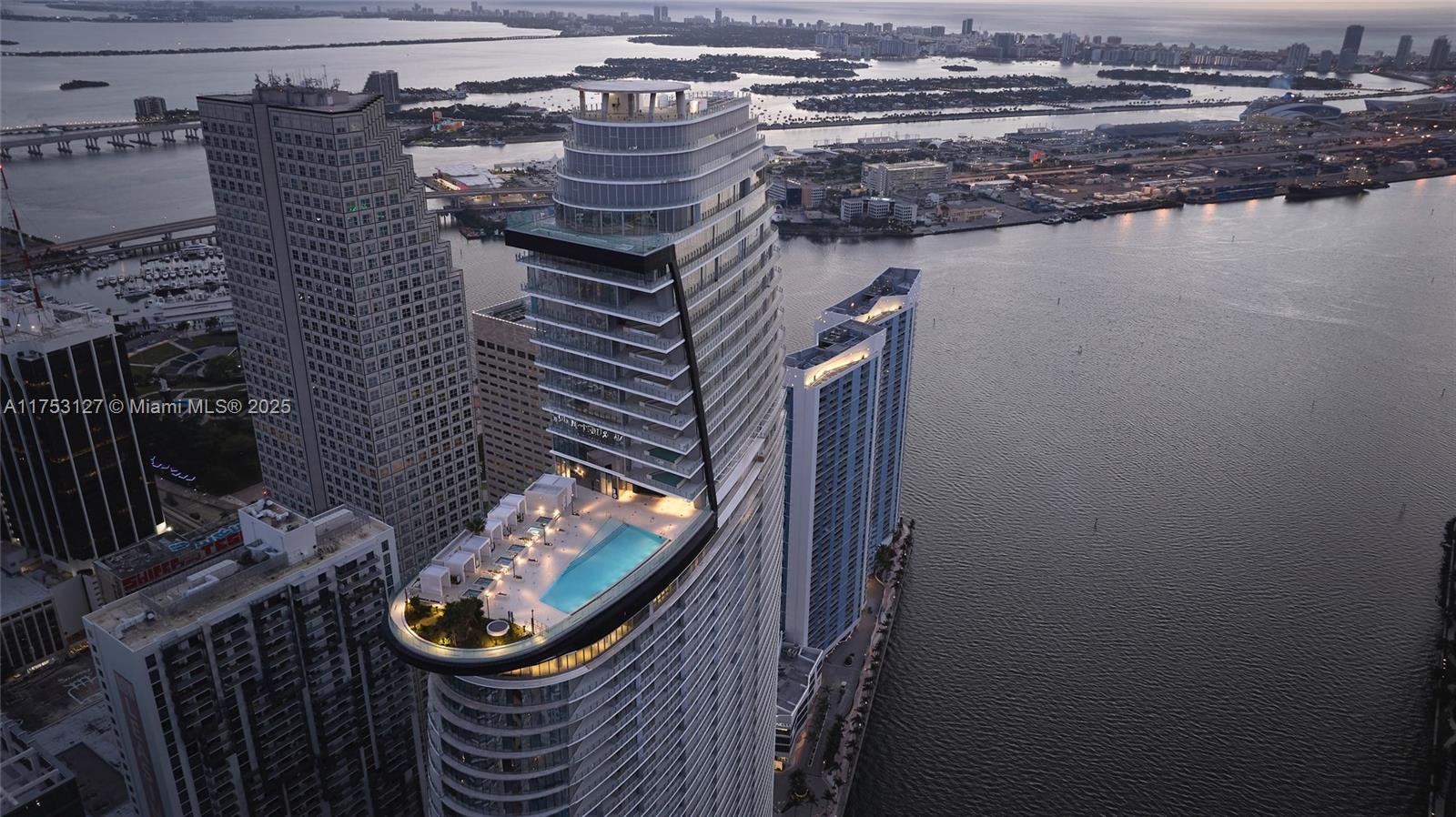 Aston Martin Residences Miami is a luxury residential tower located at 300 Biscayne Boulevard Way. Developed by G and G Business Developments, this 65-story skyscraper features 391 high-end condominiums with designs inspired by the iconic Aston Martin brand. Residences offer expansive layouts, floor-to-ceiling windows, and top-tier finishes. Amenities include a private marina, a state-of-the-art 2 floor wellness center, a sky deck with a pool, and more. The building’s sleek, modern design and prime waterfront location make it a prestigious address in Miami’s vibrant downtown area.