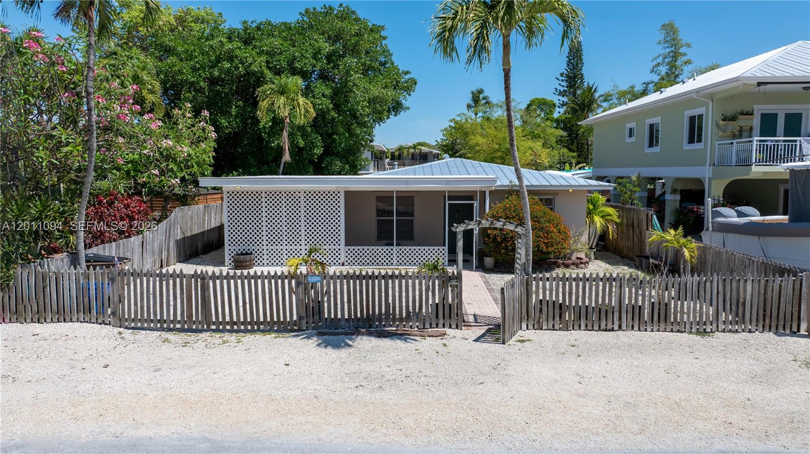Only 6 homes in from the Beach! Located in Key Largo's highly desirable Largo Sound Park neighborhood, this concrete conch home offers exclusive access to a private community park featuring a sandy beach, boat ramp, and pavilion with restrooms- all for you to enjoy the Keys lifestyle! Full of character and Old Florida charm this 2 bedroom home features a bright and open floor plan with terrazzo floors and a new roof in 2023. Off of the kitchen, there is a huge screened patio under roof that connects to a workshop - great for additional living space with excellent potential! The fully fenced yard provides ample room for multiple vehicles and a boat trailer. The spacious backyard offers endless possibilities, with plenty of room to add a pool, create an outdoor entertaining area, or simply enjoy the wide open space. This is a great opportunity to own in Largo Sound Park right by the Homeowner's park and make this house your very own! This rare location is something truly special! Live the Keys lifestyle!
