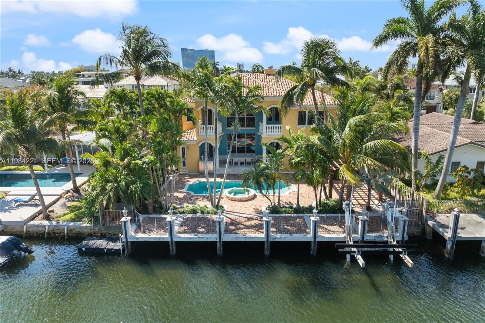 Priced to sell!  Custom 4 BR/4.5 BA waterfront residence with pool is located on 75' of deepwater and on one of the neighborhood's finest streets.  The dock features a 15,000 lb. boat lift and enjoy fast and easy access with no fixed bridges to Port Everglades Inlet.  The residence features a grand double height living room plus dining room, family room, open kitchen, custom travertine flooring throughout, a four sided custom fireplace, lower level guest suite or captain's/staff quarters with private entrance, covered patio with built in BBQ, updated pool/spa, 2 new A/C units and more.  The upper level features 2 bedrooms with en-suite baths and a grand primary suite with spa bath, dual closets and office.  Close proximity to yacht club, restaurants, beach clubs, Las Olas/Downtown, airport, cruise port and all major roads.