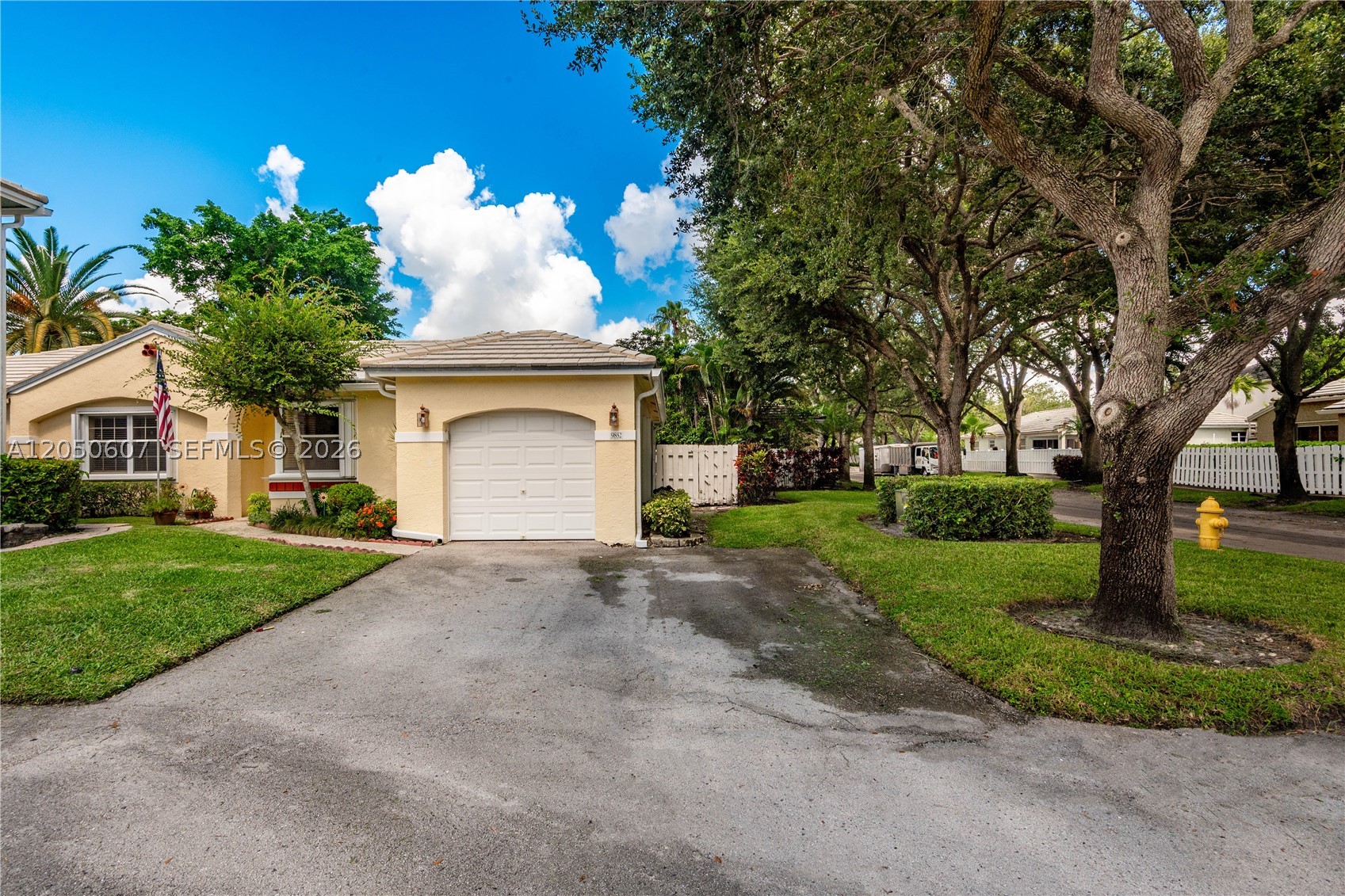 Elegant 3-bedroom, 2-bath single-family home in the highly sought-after Jacaranda community of Plantation! This beautifully maintained residence offers the perfect blend of comfort, style, and functionality. Filled with natural light, the home features volume ceilings, rich natural wood floors, and spacious living and dining areas. Enjoy peace of mind with a new tile roof and new A/C unit. The updated kitchen showcases new hardwood cabinetry and includes a new washer and dryer for added convenience. The spacious primary suite features a large walk-in closet and a private bath, creating a relaxing retreat. Step outside to a large patio, perfect for entertaining, relaxing, or enjoying outdoor dining. Situated on a desirable corner lot, the property also features a one-car garage and offers added privacy and curb appeal. Located in one of Plantation's most desirable family-friendly neighborhoods, this home is conveniently close to top-rated schools, parks, shopping, dining, and major highways. A rare opportunity you won't want to miss!