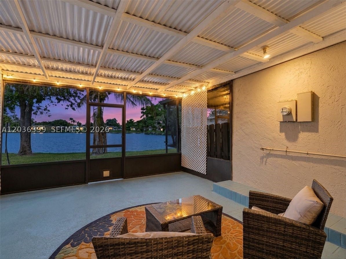 Welcome to your private lakefront oasis in Westview! This bright, sun-drenched 1,040 sq ft townhouse offers direct lake access and stunning water views right from your spacious living area. Perfect for entertaining, the main level features a convenient half-bath and a seamless transition to a covered patio—ideal for hosting guests by the water. Upstairs, you'll find generously sized bedrooms and a full bath. The kitchen boasts stainless steel appliances and crisp white wood cabinetry, complemented by durable laminate and tile flooring throughout. Enjoy resort-style community amenities including a clubhouse, gym, pool, and tennis courts. Minutes from Pembroke Lakes Mall. Bonus: No special assessments and the 40-year certification is already complete! On Zillow, scroll down to "facts & features", click on "show more", then click "View virtual tour" for your Virtual Interactive Lifestyle Concierge!