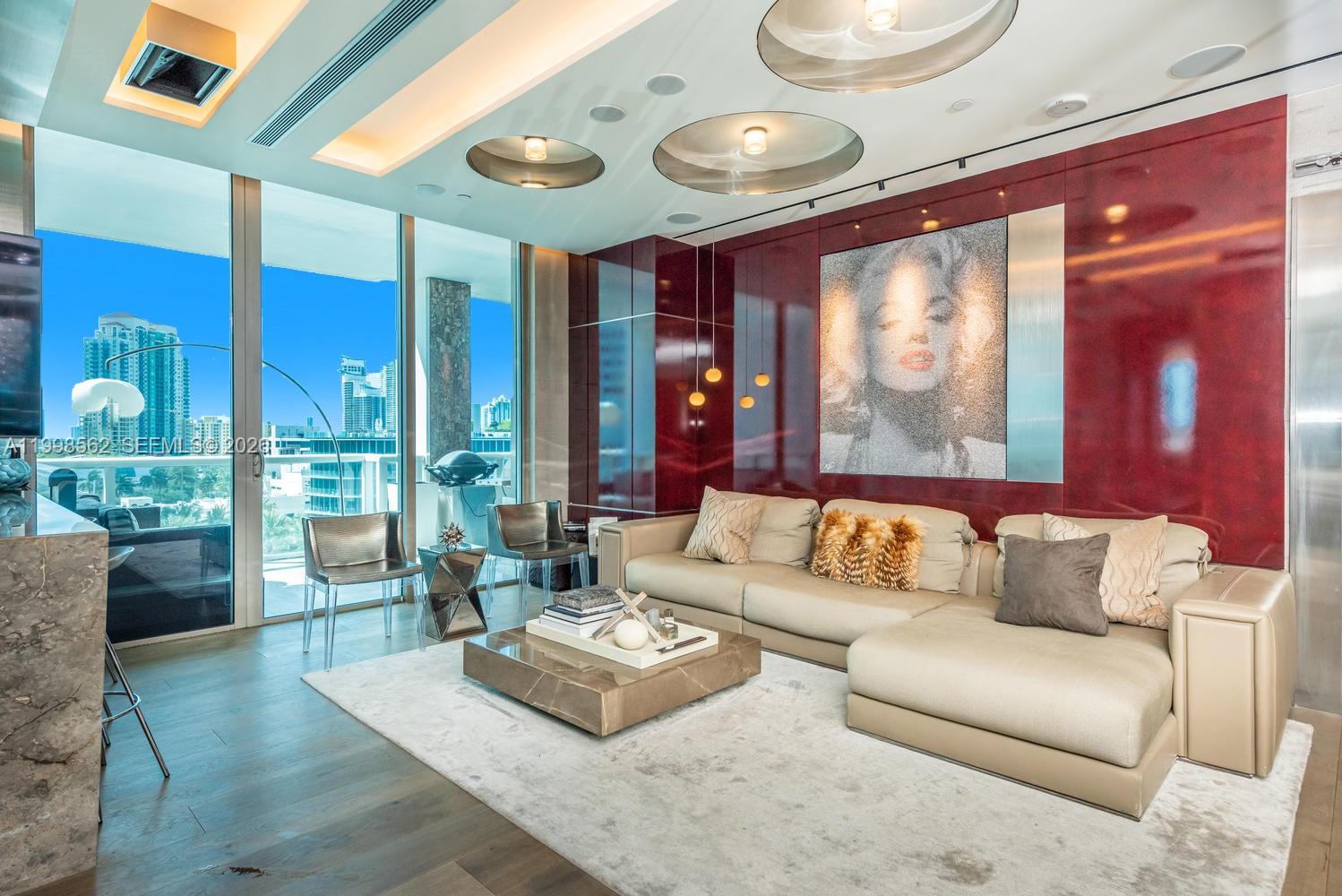 Newly renovated with a refined modern aesthetic, this residence at Continuum offers a seamless blend of style and functionality. Designed for entertaining, the open living and kitchen areas flow effortlessly, anchored by a spacious bar ideal for hosting—all within a desirable split-wing 2-bedroom floor plan.

Southwest exposure fills the home with natural light, while three expansive open balconies on a unique transition level (no overhead ceilings) create multiple outdoor living spaces, including a striking marble bar table for al fresco gatherings.

Thoughtfully upgraded with wood flooring throughout, custom ceiling lighting, electronic shades, and integrated Crestron control, the residence also features built-in surround sound for a cinematic experience.