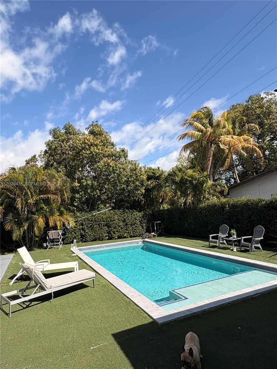 This beautifully maintained single-story Mid-Century Modern home offers over 2,000 sq ft of living space in a classic Florida ranch-style design. The spacious layout includes a bright, open living room with sliding doors that overlook a large backyard and pool area, a light-filled kitchen, four bedrooms, two full bathrooms, a separate laundry room, and an attached garage. The property is equipped with 47 solar panels, offering significant energy efficiency. Investor opportunity: The home is currently tenant-occupied through 08/31/2026, with the tenant paying $5,500 per month and willing to renovate for another year. Please note: Showings only with 24 hours advance notice . A video tour is available upon request.