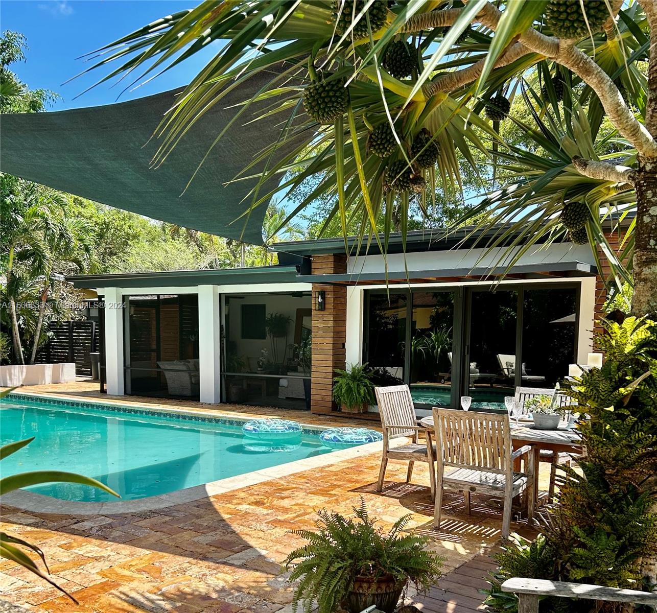 This charming ranch-style home, nestled among majestic trees on a serene street in Plantation, has undergone extensive renovations to offer a blend of modern comfort and timeless elegance. With a new shingle roof, newer diamond brite pool finish, and impact windows throughout, it exudes durability and style. Inside, the remodeled kitchen and three full baths feature contemporary finishes, while travertine floors in the living areas and bathrooms, paired with hardwood floors in the bedrooms, add a touch of sophistication. A cozy wood-burning fireplace beckons gatherings in the living room, while the outdoor patio and pool area, adorned with rustic travertine floors and equipped with an outdoor pizza. House is rented furnished or unfurnished.