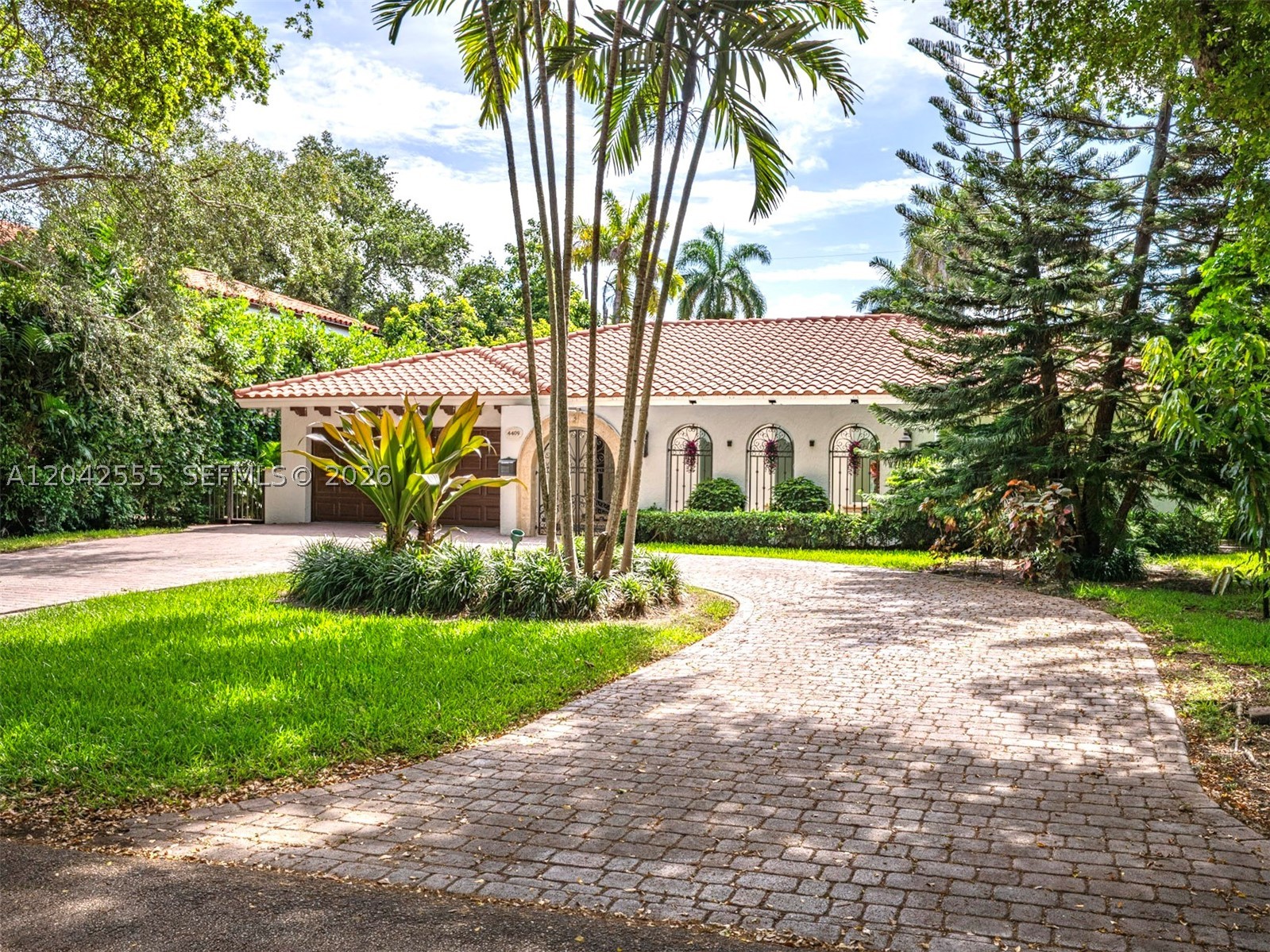 Experience Coral Gables living at 4409 Monserrate Street. This one-story residence offers 4 bedrooms, 2.5 bathrooms, and 2,235 square feet of interior living space on a quiet, oak-lined street. The functional split floor plan places the primary suite on one side of the home and the additional bedrooms on the other. The open kitchen flows seamlessly into the family room and living room, creating a comfortable layout for everyday living and entertaining. Additional features include a dedicated laundry room, a two-car garage, and a spacious driveway. Outdoors, enjoy a private pool and patio area, ideal for relaxing or gathering with guests. Conveniently located in Coral Gables, moments from the Shops at Merrick Park, dining, shopping, and everyday conveniences.