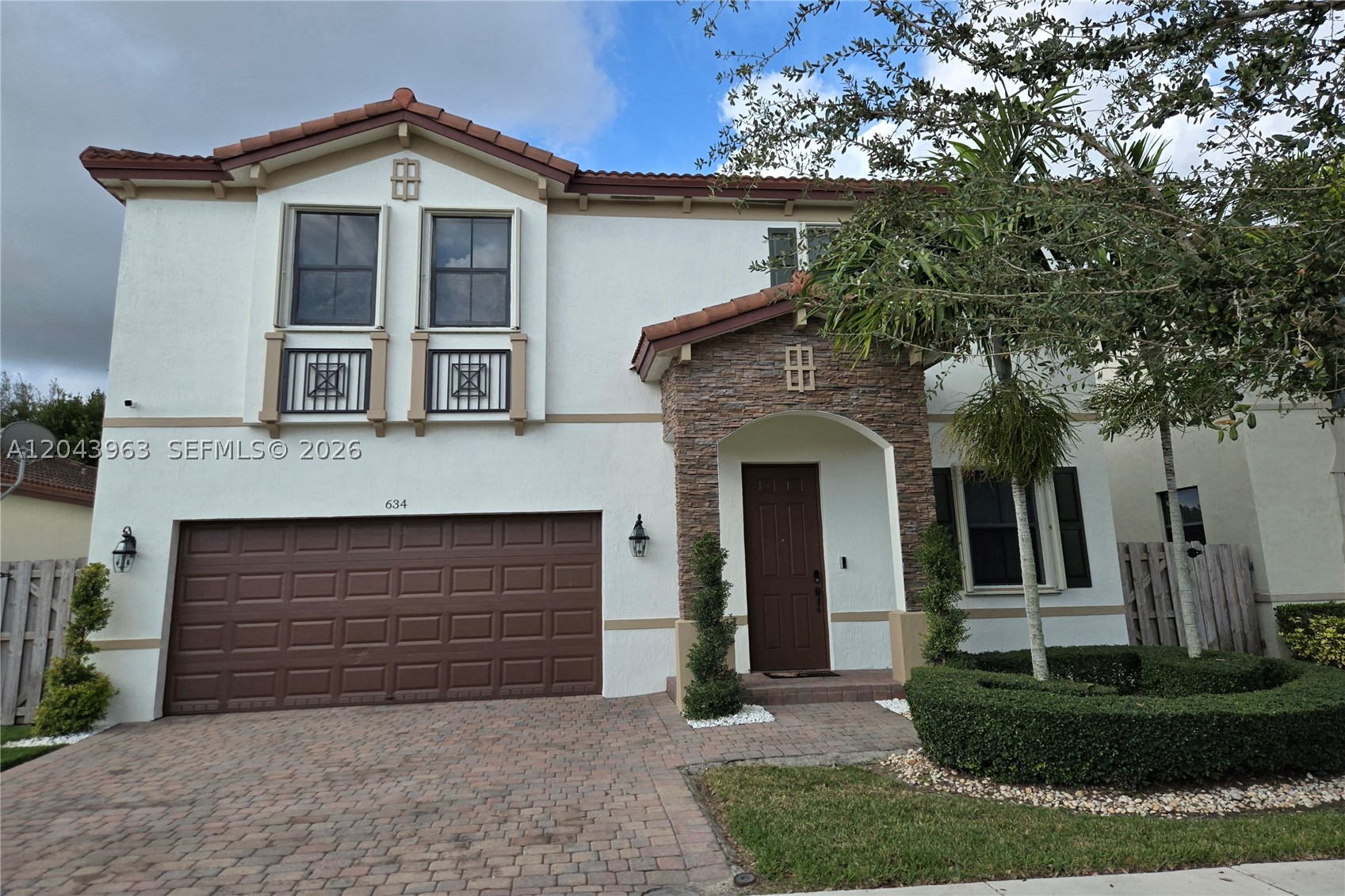 Gorgeous 2 story gated home offers you so much. It's in Move in ready and remodeled condition. This home has 4 large sized bedrooms with very spacious closets. Master suite has 2 walk-in closets and an elegant bathroom with shower and tub. Washer and Dryer are upstairs for your comfort. Laminated wood floors throughout the entire house and porcelain floors in kitchen and baths. Kitchen has marble countertops and updated appliances. A/c and Roof are 11 years and still in great shape. Hurricane shutters on all windows. Extra large 2 car garage. Spacious backyard, ready for a pool or a pergola. Management office is on the premises and has pool and gym. Let's make this your home.