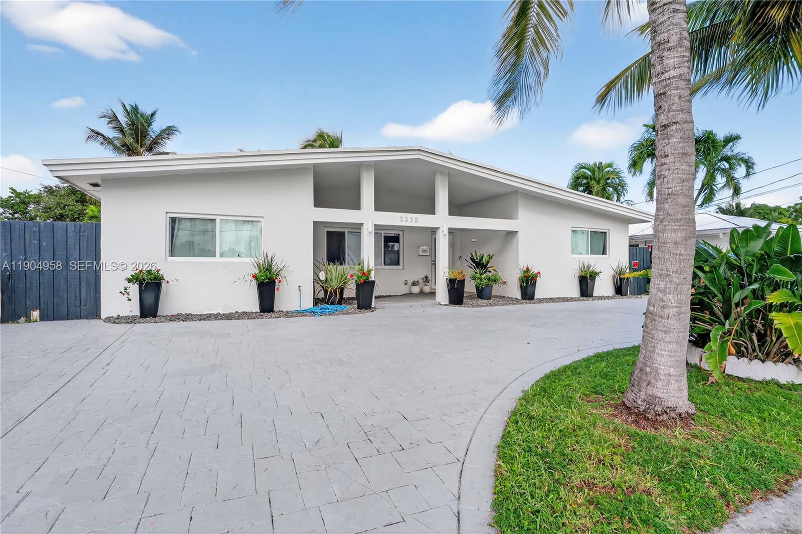 Best price, inside Enchanted Lakes guard gated community, the waterway is ocean access. This remodeled, 4/3, 2240 sq ft, minimalist design So Flo home awaits you. A perfect opportunity to indulge in a lifestyle of luxury, comfort & joy. Plus, Seller concessions towards buyer. Open space with a great layout for comfort and joy. The backyard is a bountiful oasis with serene park like vibes. This home is a lifestyle today with limitless potential for tomorrow. It's a rare find at an incredible value. New roof, restored plumbing with dual zone clean outs, hurricane impact doors/sliders/windows, custom wood kitchen maple wood cabinets: Utility/Laundry, Island, peninsula plus quartzite leatherette countertops. You can entertain indoor/outdoor or dine al fresco. The master suite/walk in closet/ensuite are spacious and private, high end plumbing features, floors and wall are porcelain tiles, smart lighting and smart appliances that promises an innovative lifestyle. This home is sleek and holds an unparallel high end value. The wide canal leads to nearby lakes, parks, intracoastal and the ocean. Easily accessible through small craft aka wave runners. Makes it an ideal escape from the office, busy life to a serene retreat. That's why those who vacation here, relocate and enjoy the perks of being part of this community. Easy to show text listing agent.
