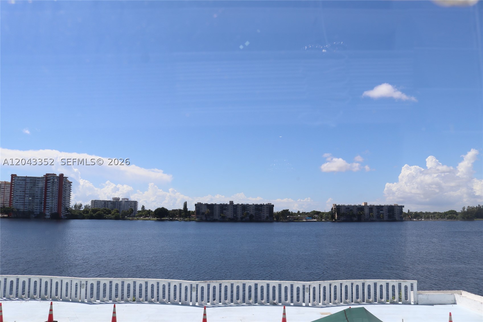 Welcome to this beautifully updated waterfront condo offering comfort, style, and breathtaking direct lake views. This spacious residence features 1 bedroom, 1.5 bathrooms, a versatile den, and assigned covered parking. The open-concept living and dining area showcases large-format porcelain tile flooring, abundant natural light, and stunning water views that create a bright and inviting atmosphere. Impact windows and doors throughout. The remodeled kitchen boasts granite countertops, rich wood cabinetry, stainless steel appliances, a modern range hood, and ample cabinet storage. The generously sized primary bedroom features a walk-in closet and an updated en-suite bathroom with a beautifully tiled walk-in shower, while the renovated guest half bath adds convenience. The spacious den offers endless possibilities as a home office, guest room, or additional living space.

Enjoy lake views from the living room and den while being conveniently located near Aventura Mall, Gulfstream Park, Brightline, I-95, the Turnpike, shopping, dining, and beautiful beaches. Residents enjoy a clubhouse, fitness center, and a community pool currently being renovated, with completion anticipated by the end of 2026. Low HOA. This well-maintained, Tenant occupied month-month paying $2,100, can stay or vacate at closing, waterfront condo presents an exceptional opportunity to own in one of the area's most convenient and rapidly growing locations. 24-hour notice required for showings.