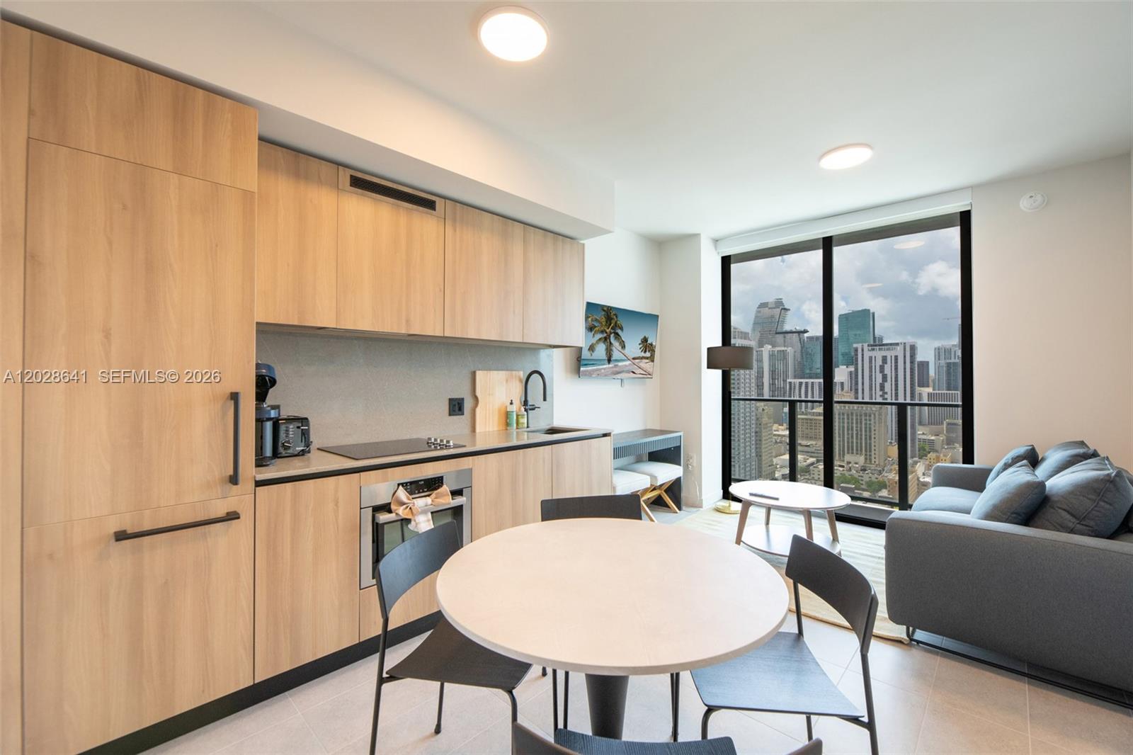 Welcome to 501 First Residences unit 3103 at Miami Worldcenter, one of Downtown Miami's newest residential addresses. Completed in 2025, this never-lived-in residence offers 1 bedroom, 2 full bathrooms, and a spacious den, fully furnished and thoughtfully appointed for an effortless move-in experience.

Designed with flexibility in mind, the layout provides a seamless blend of comfort and functionality. The generous den offers valuable additional space, ideal for a home office, guest area, or creative workspace, while expansive windows fill the residence with natural light and showcase vibrant city views. Carefully selected furnishings and refined details create an inviting atmosphere that feels both comfortable and sophisticated.

Residents enjoy an exceptional collection of amenities located on the building's highest floors and rooftop, offering panoramic views of Miami's skyline and Biscayne Bay. Ideally situated within Miami Worldcenter, the residence is moments from acclaimed dining, entertainment, shopping, cultural destinations, and convenient transportation, placing the best of Downtown Miami within easy reach.