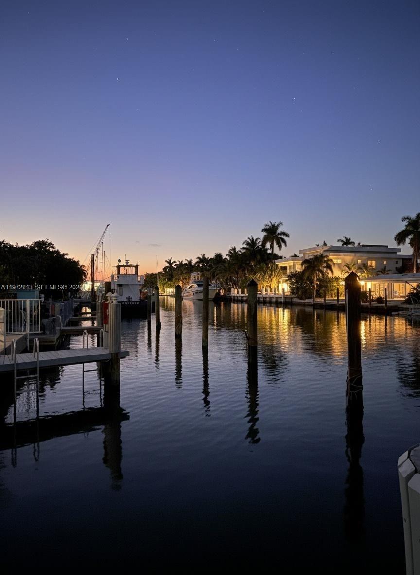Prestigious Las Olas Isles — where the boating lifestyle meets refined waterfront living. Nearly 3,000 SF of fully upgraded interiors that live like a single-family home, without the maintenance, in one of Fort Lauderdale's most coveted boutique waterfront enclaves. Deeded dockage with a 24,000 lb capacity lift for vessels up to 40 feet and no fixed bridges to the open ocean — Port Everglades and the Intracoastal are minutes away, effortless every day. An enormous, loft-feel open-concept main room frames the water from every angle — because on the Isles, the view is the lifestyle. As a corner residence, water views follow you throughout — including into the primary bedroom and oversized guest suite. The second vantage point offers the water view opening alongside the building's pool and lush landscaped amenity area. Bathed in natural light and water reminders. The primary suite is a genuine luxury hotel retreat — private, expansive, and appointed for comfort — with its own private terrace. A second all-weather terrace looks straight down the canal, offering an endless parade of boats and yachts as a front-row seat to the waterfront life, rain or shine. Over $255,000 in recent investments make this entirely turn-key — new hurricane impact glass, seamless indoor-outdoor flooring, bespoke custom closets, designer lighting, and a striking architectural built-in fireplace anchoring the main living space. Nothing left to do.